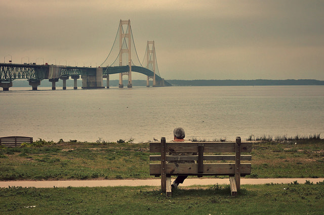 Person sitting alone on a park bench in Michigan