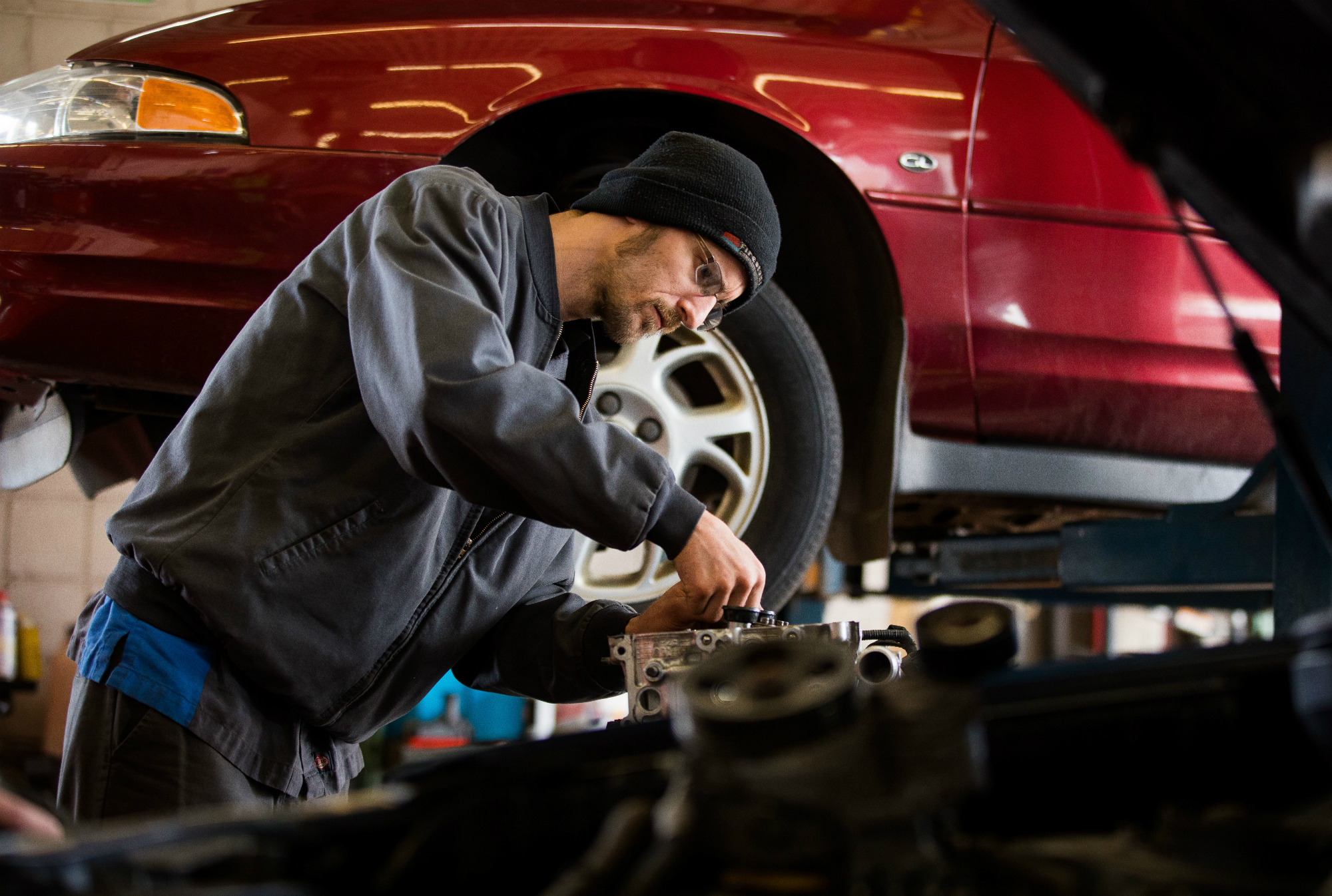 Mechanic Mike Pinor works on an engine