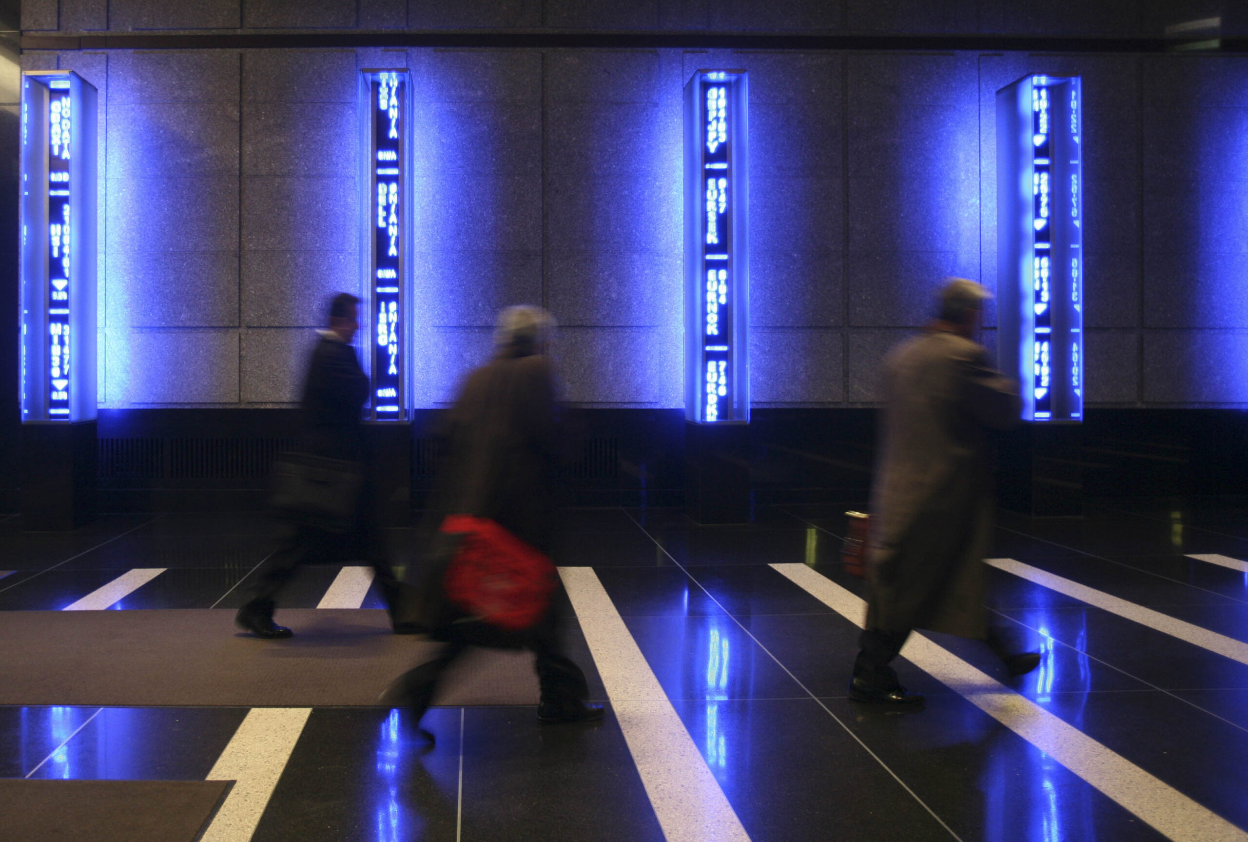 Employees cross the lobby at Bear Stearns