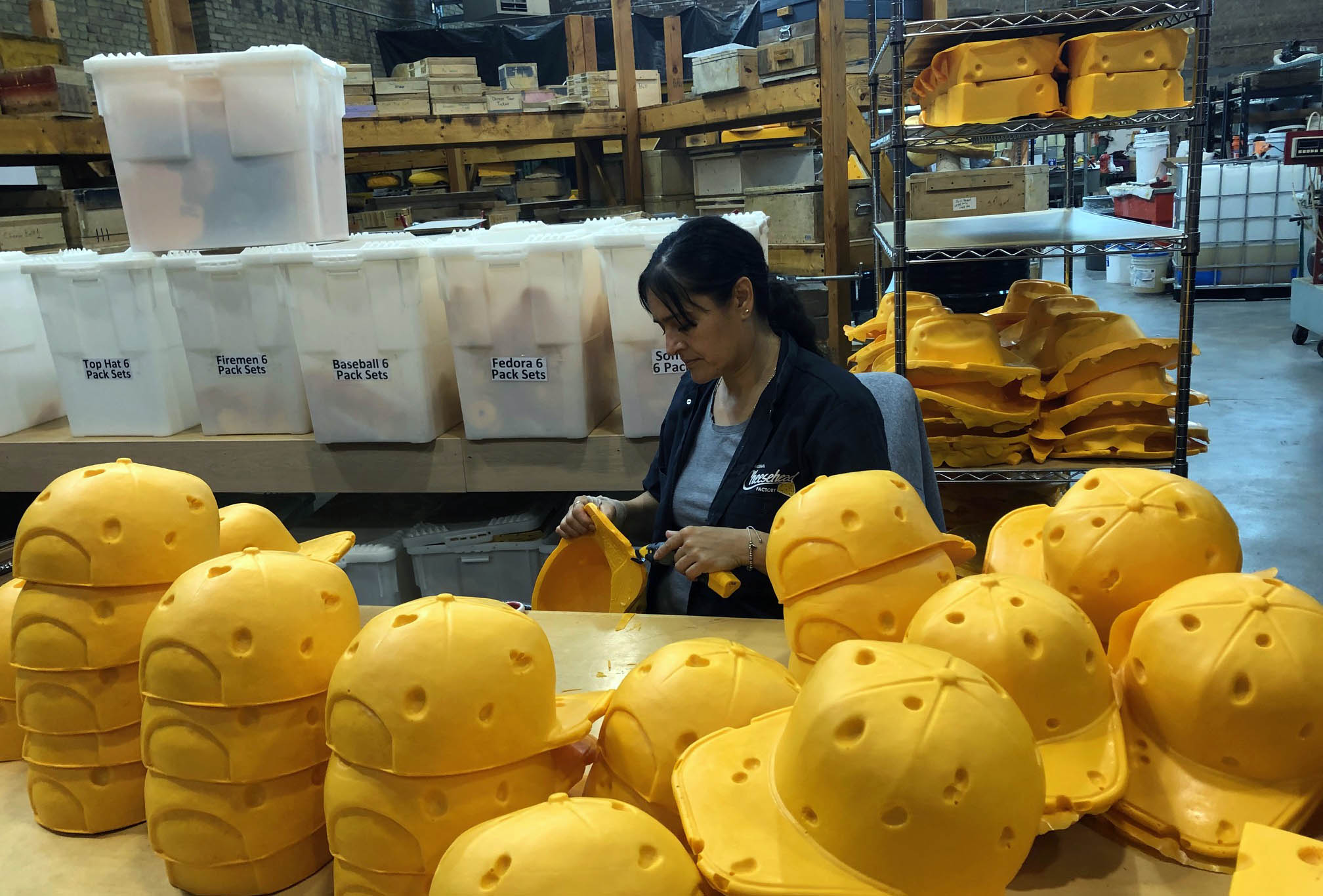 Maria Ruiz trims excess foam off cheehead hats