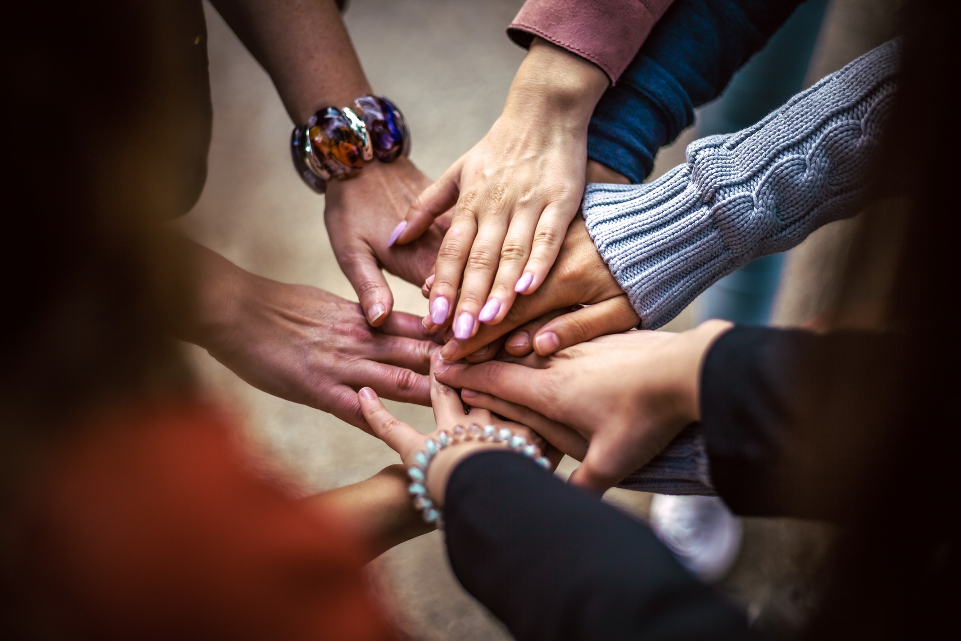 A group of people put their hands togehter