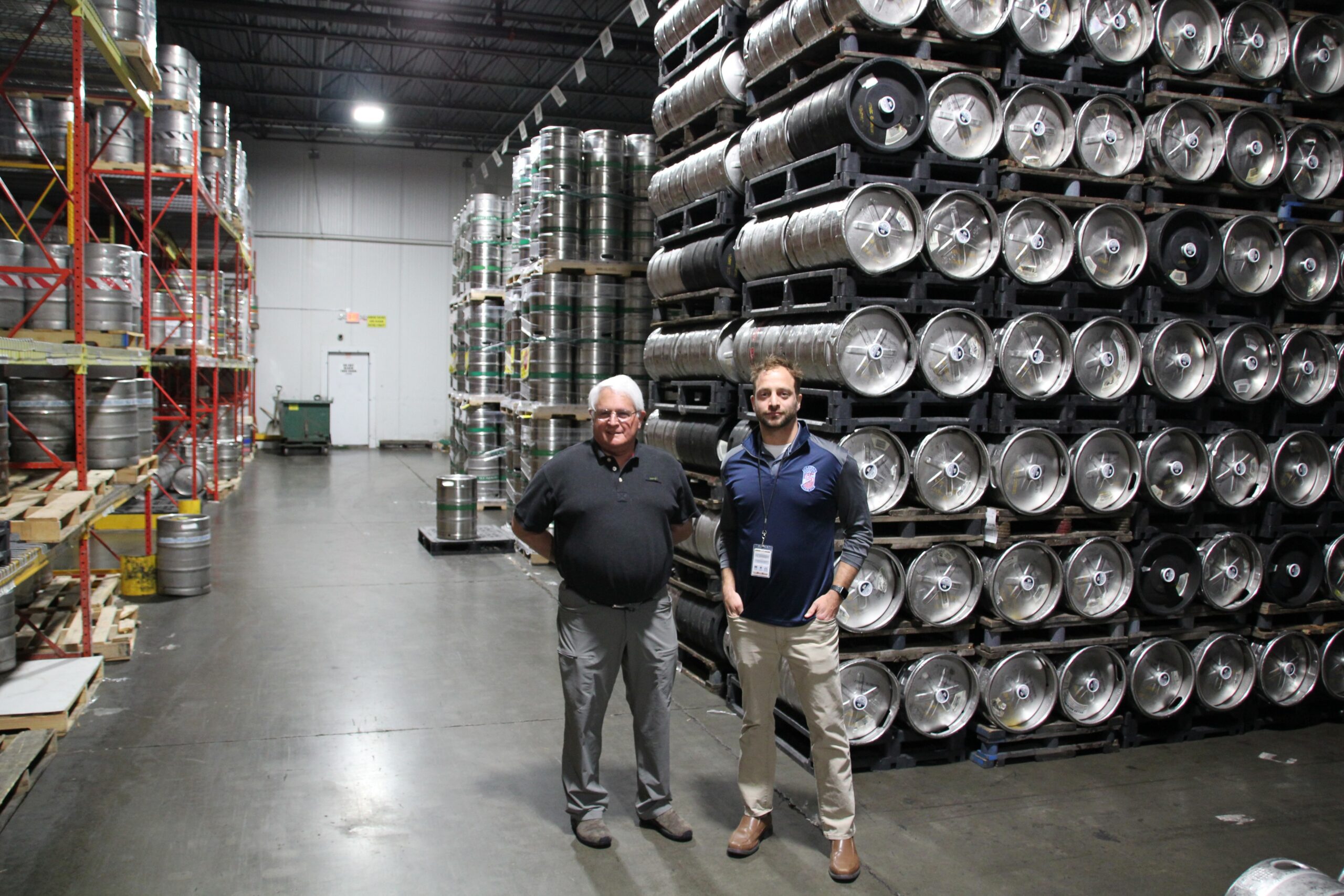 Steve and Mike Frank of Frank Beverage Group stand in front of kegs of Miller Lite and New Glarus Spotted Cow in their Middleton, WI warehouse.