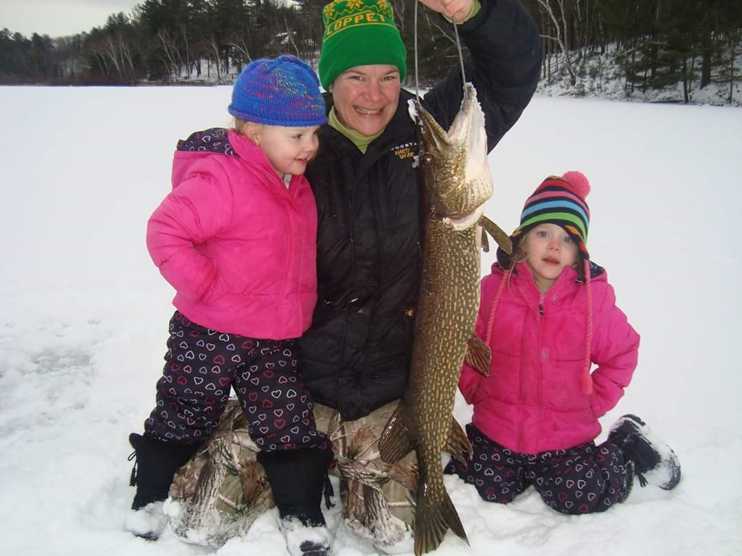 Family with children ice fishing