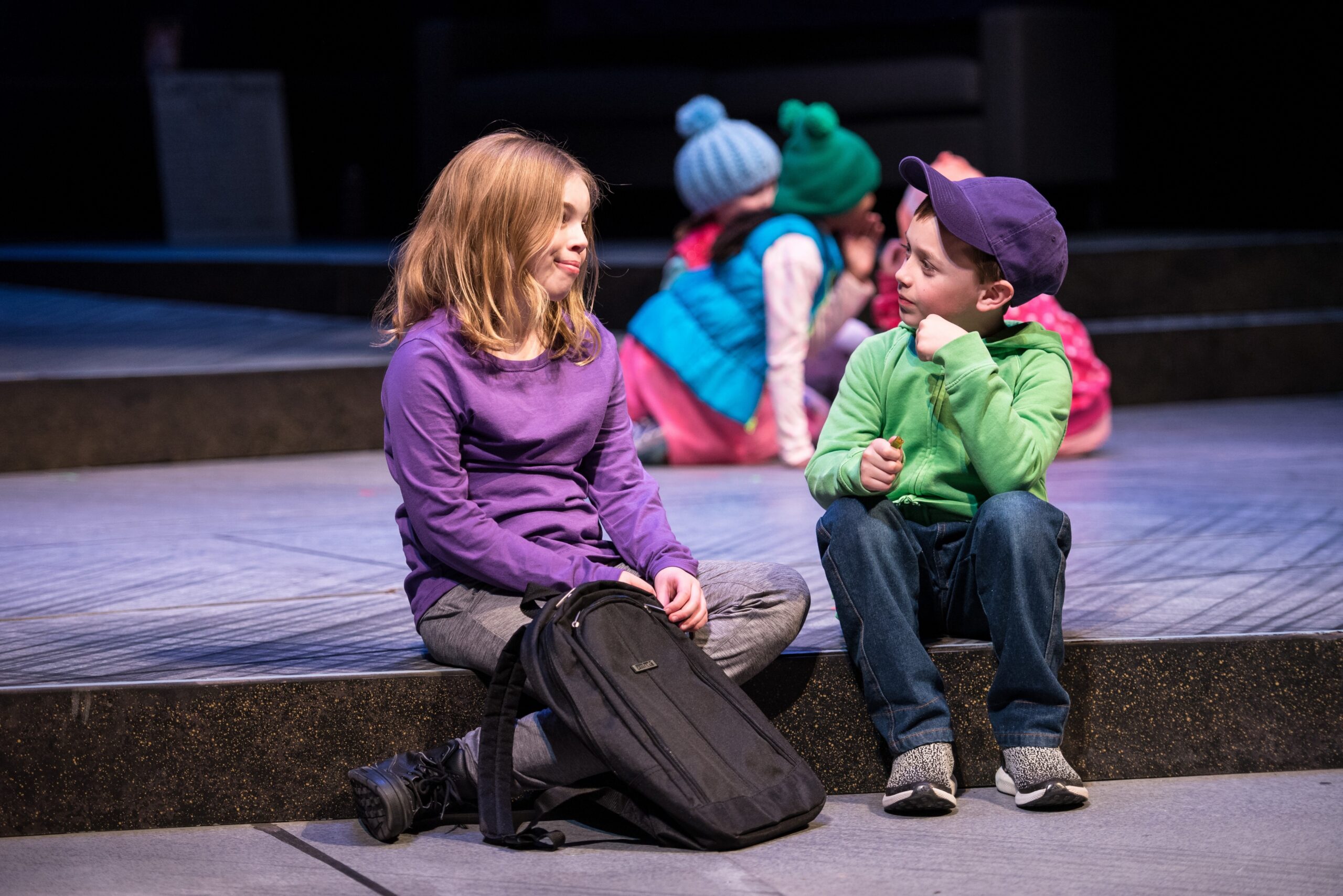 two children on a theater stage talking