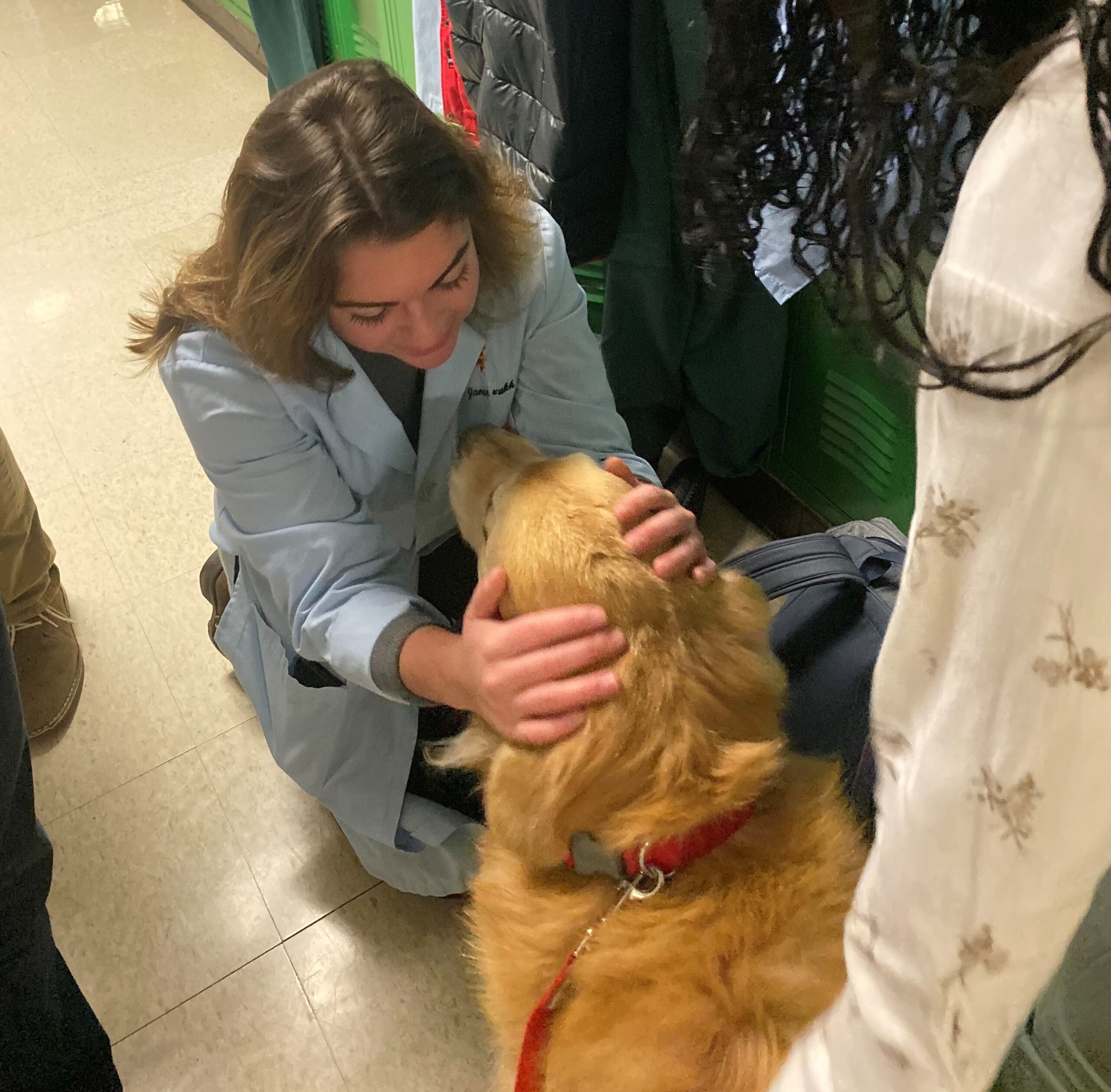 Scout greets veterinary students in the hallway