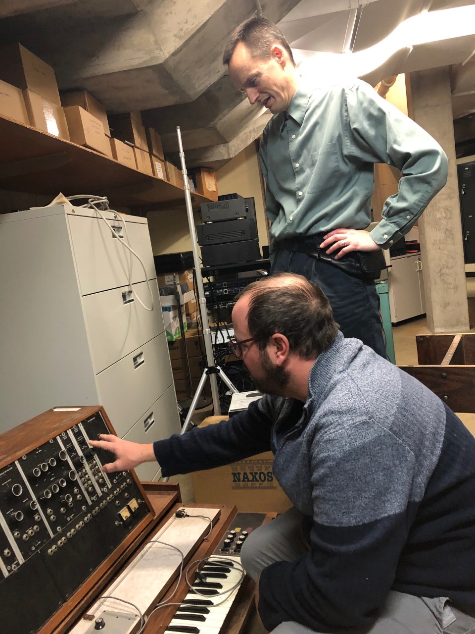 Nigel O'Shea inspects the UW-Madison Mead Witter School of Music's Moog synthesizer with Brian Heller.