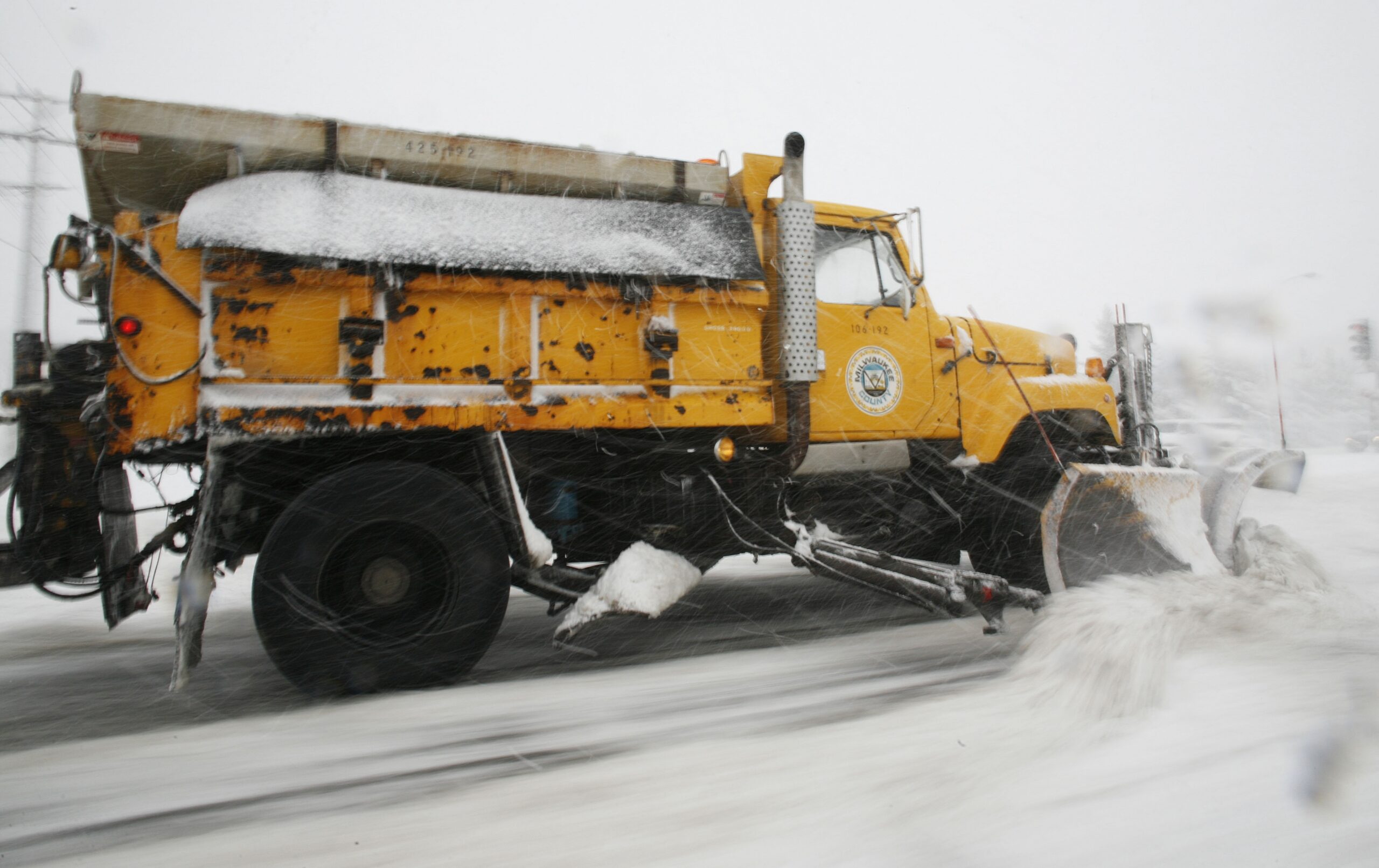 A Milwaukee County plow clears a street in Wauwatosa