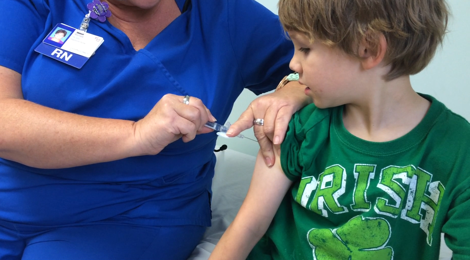 A young boy receiving a flu shot.