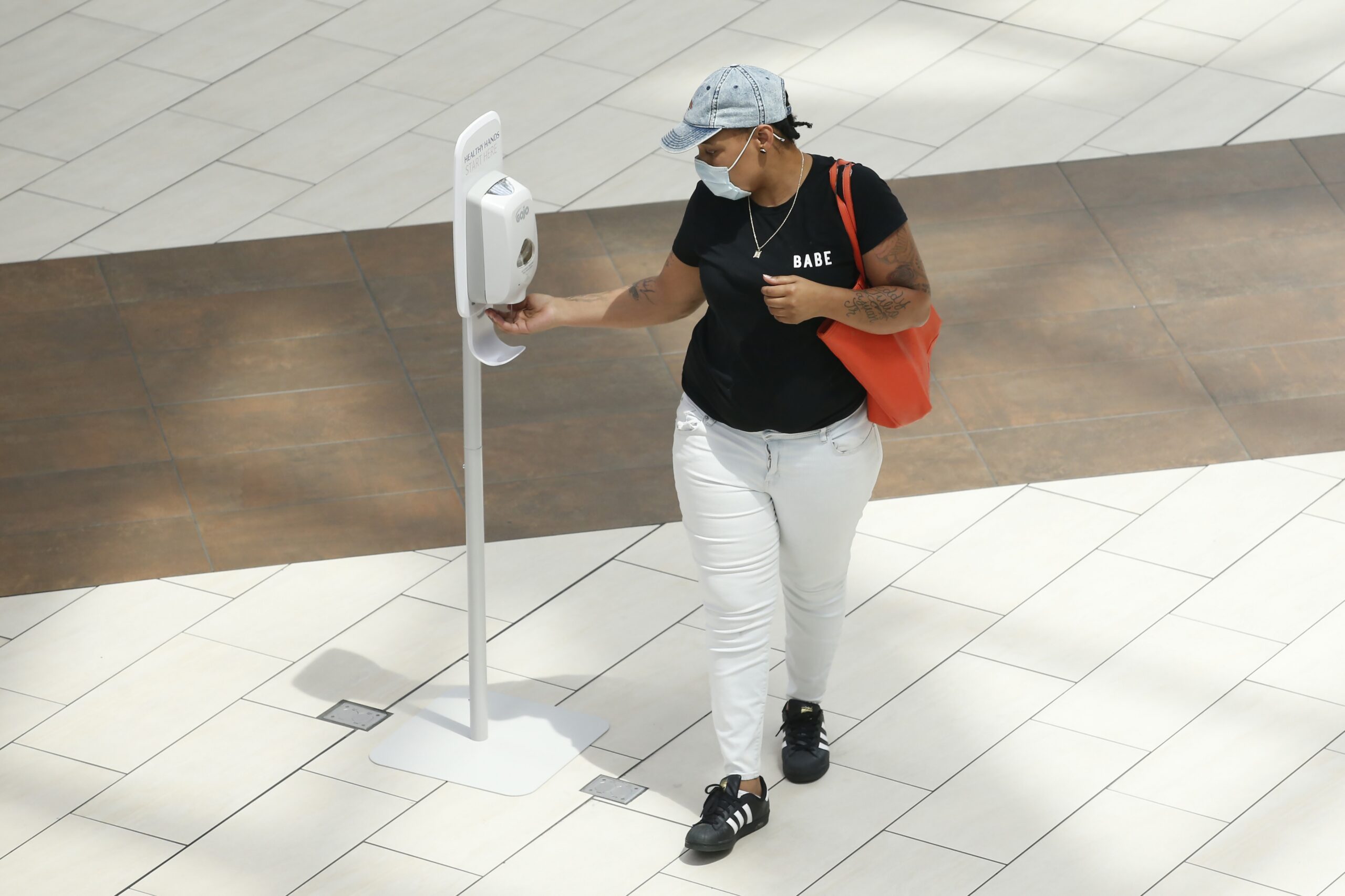 A person stops for some hand sanitizer at the Arden Fair Mall