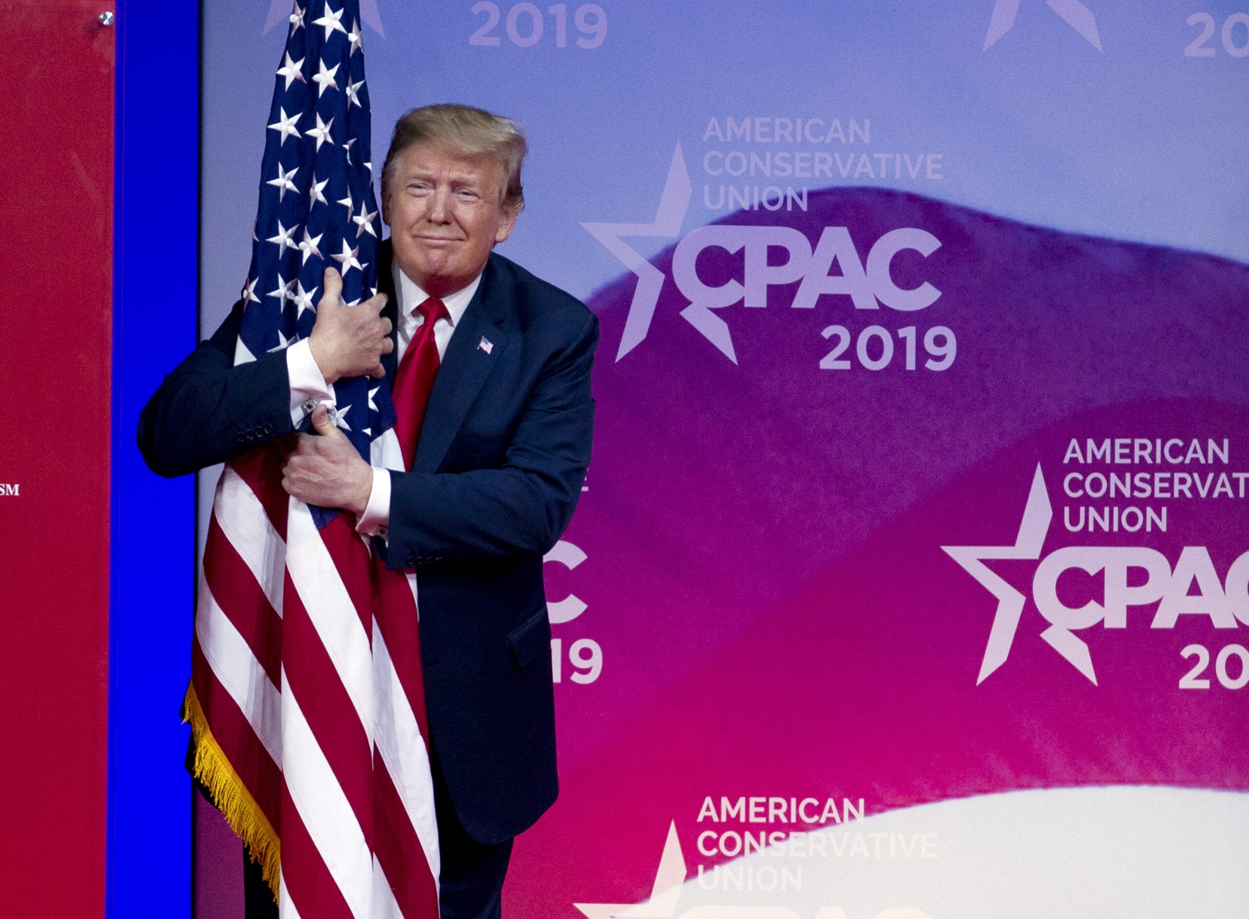 President Trump hugging a flag