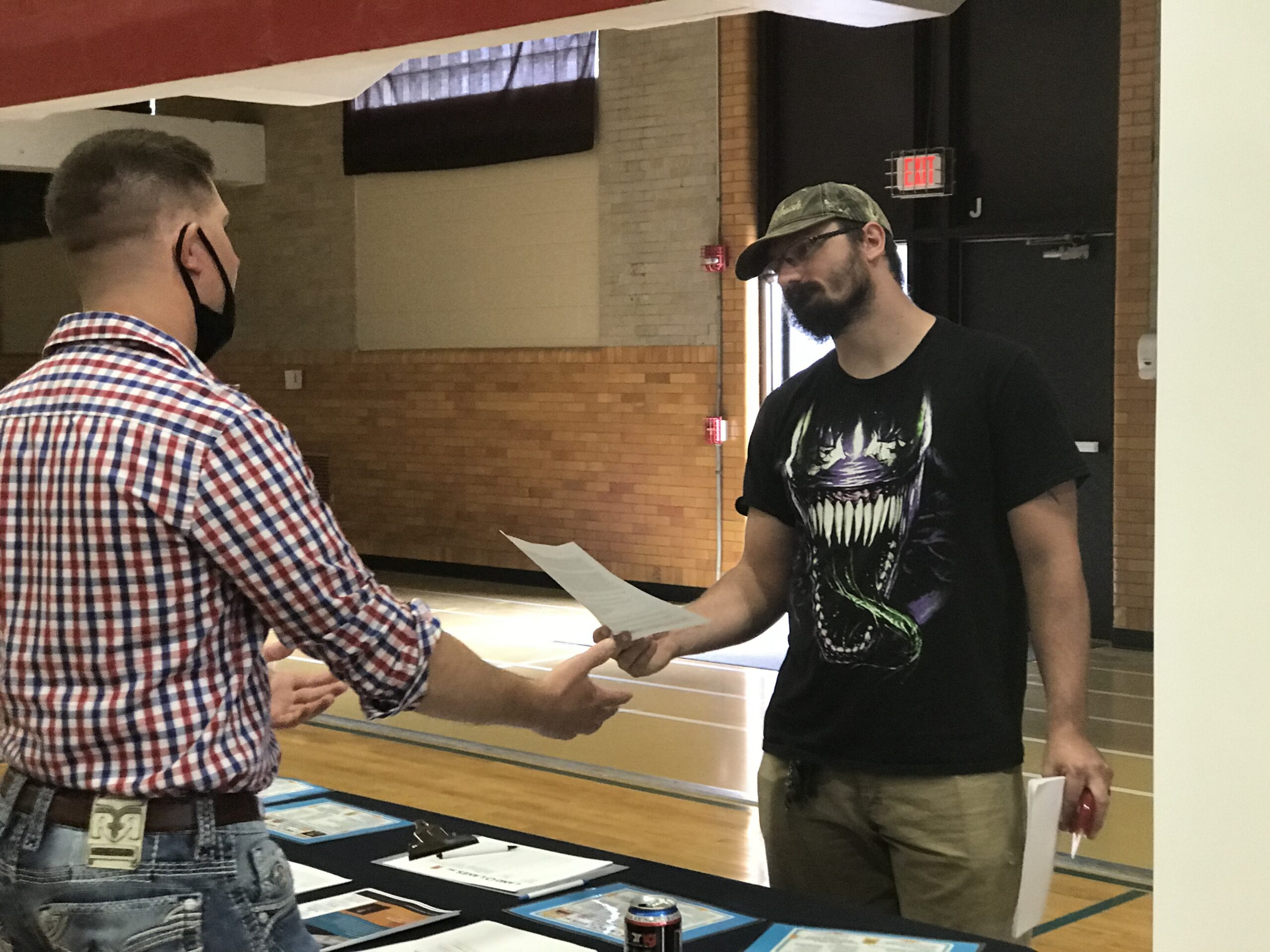 Verso worker John Uphoff speaks to an employer at a job fair in Wisconsin Rapids