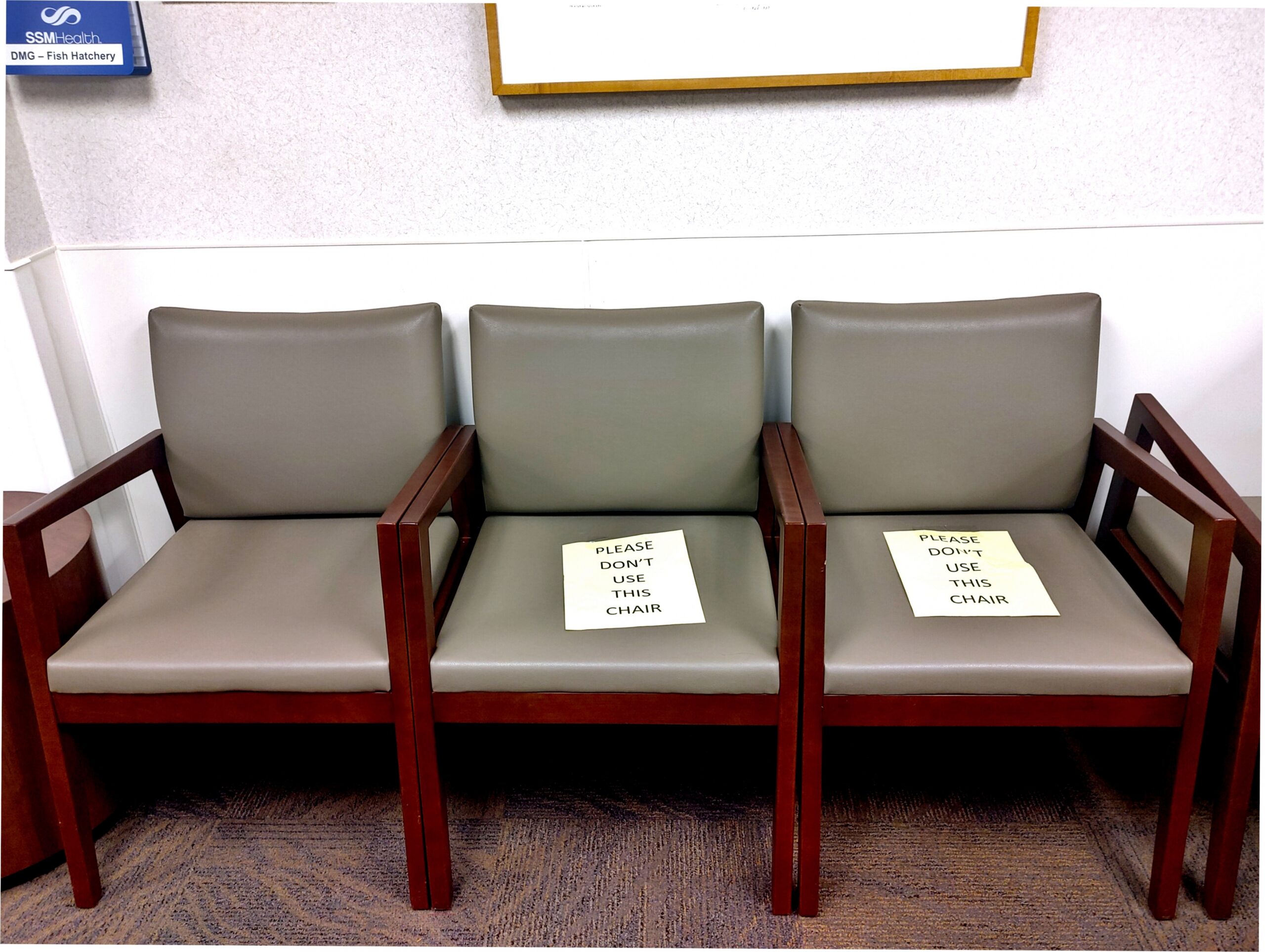 Signs on chairs warning patients to maintain social distancing at one SSM Health clinic on the south side of Madison