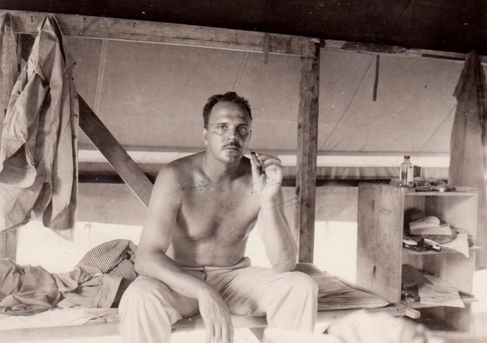 Frank Tachovsky resting on a bunk during World War II.