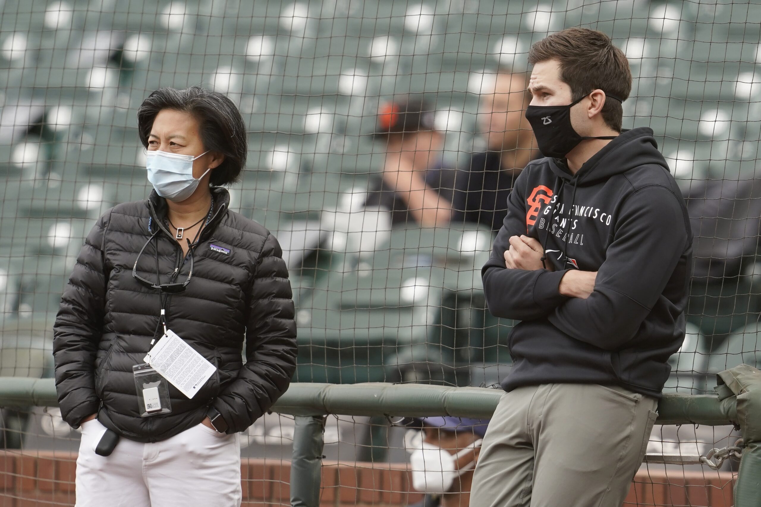 Miami Marlins general manager Kim Ng chats with a colleague before a game