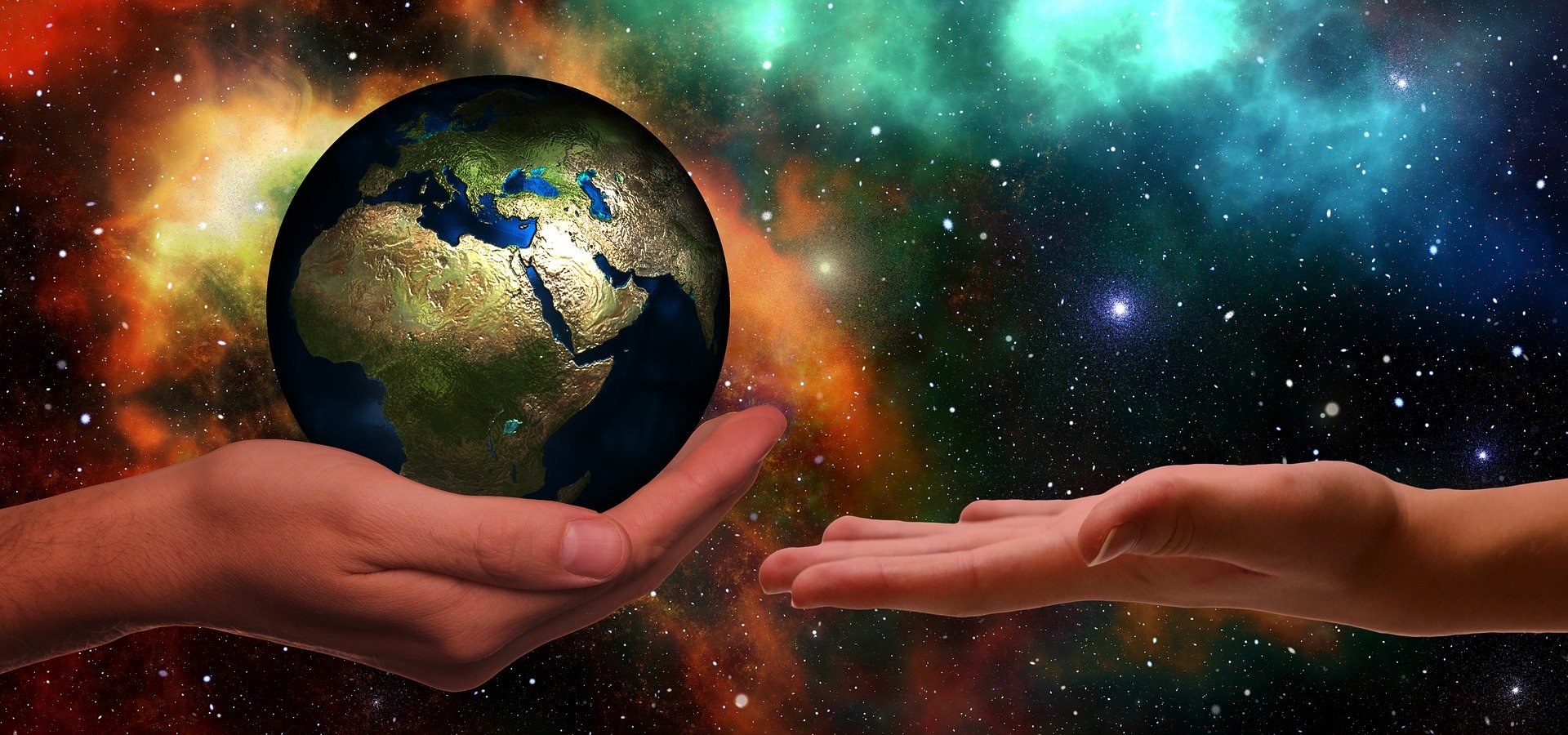 Image of adult hand giving the earth to a younger generation.