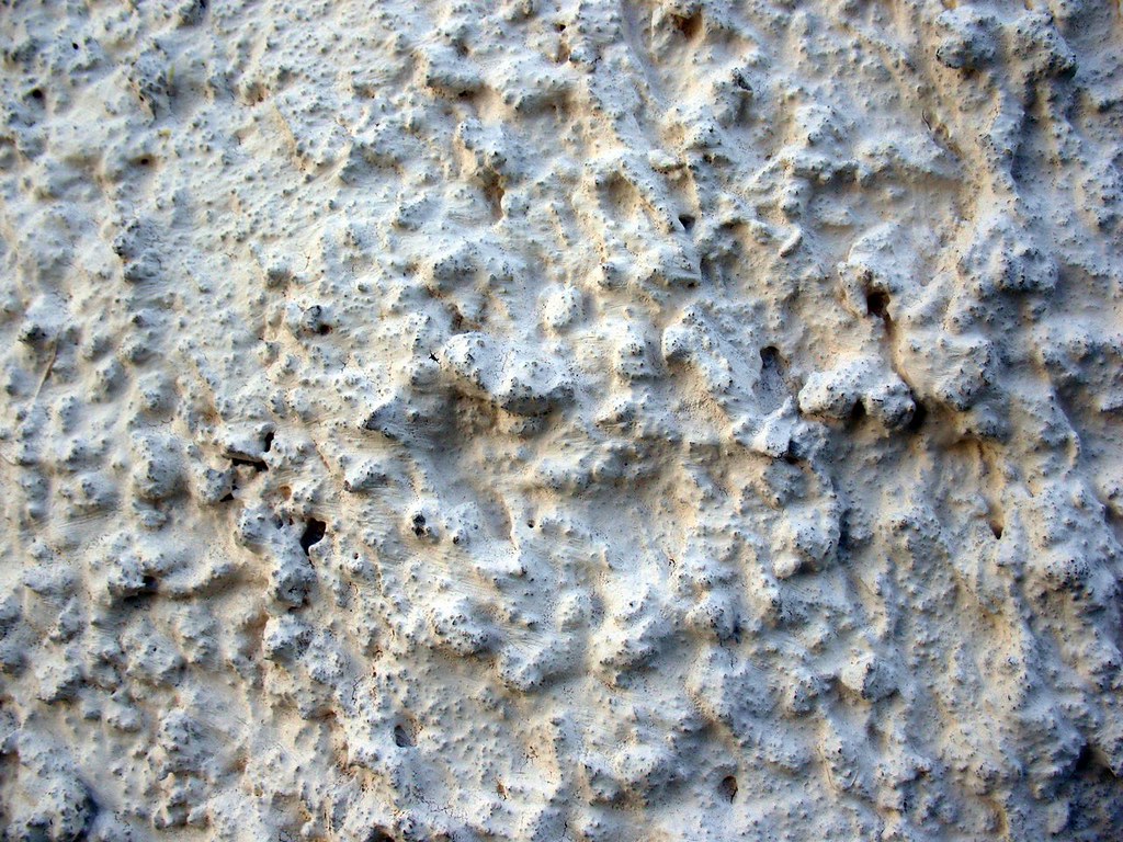 Lumpy stucco wall.