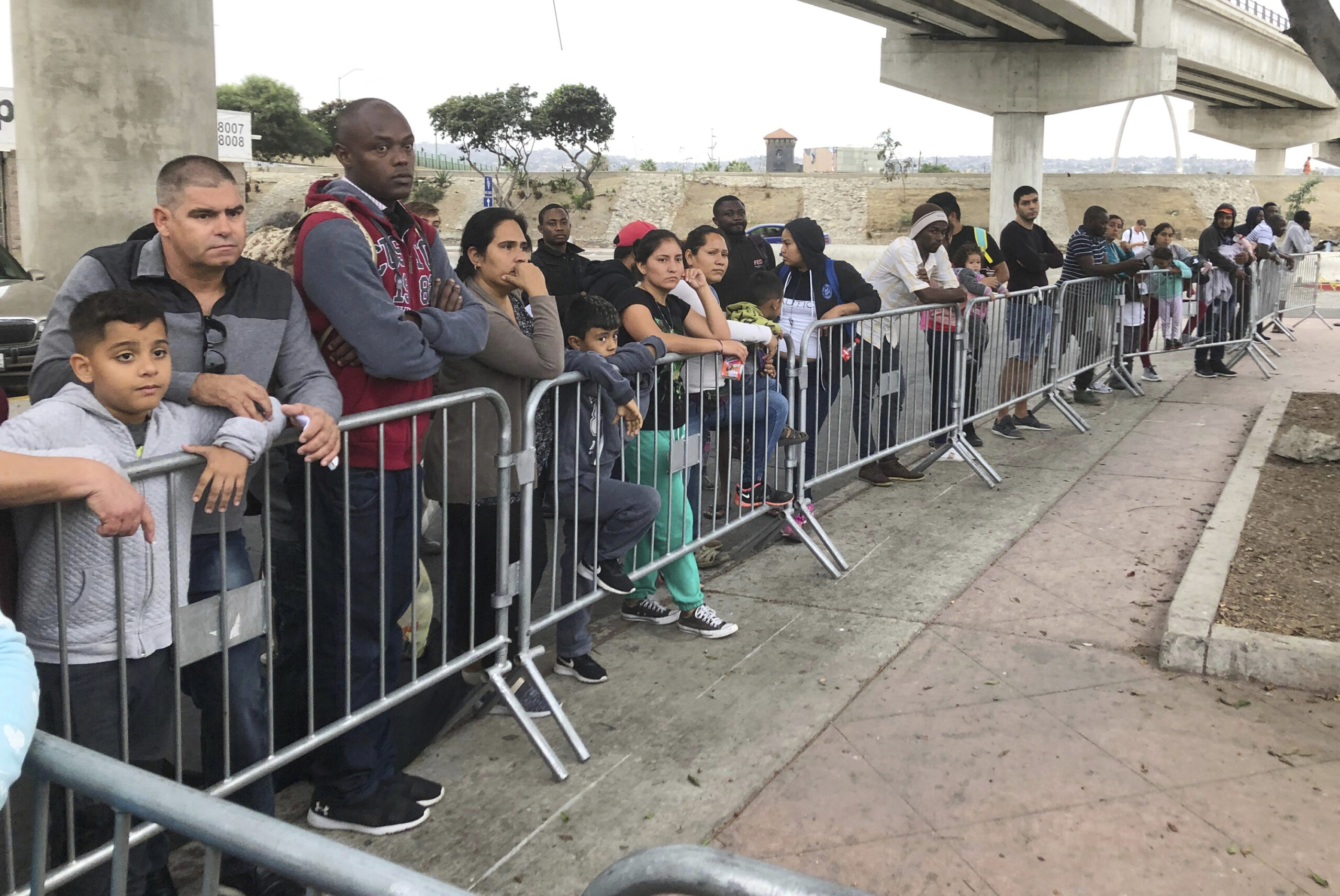 Asylum seekers wait in line in Tijuana, Mexico