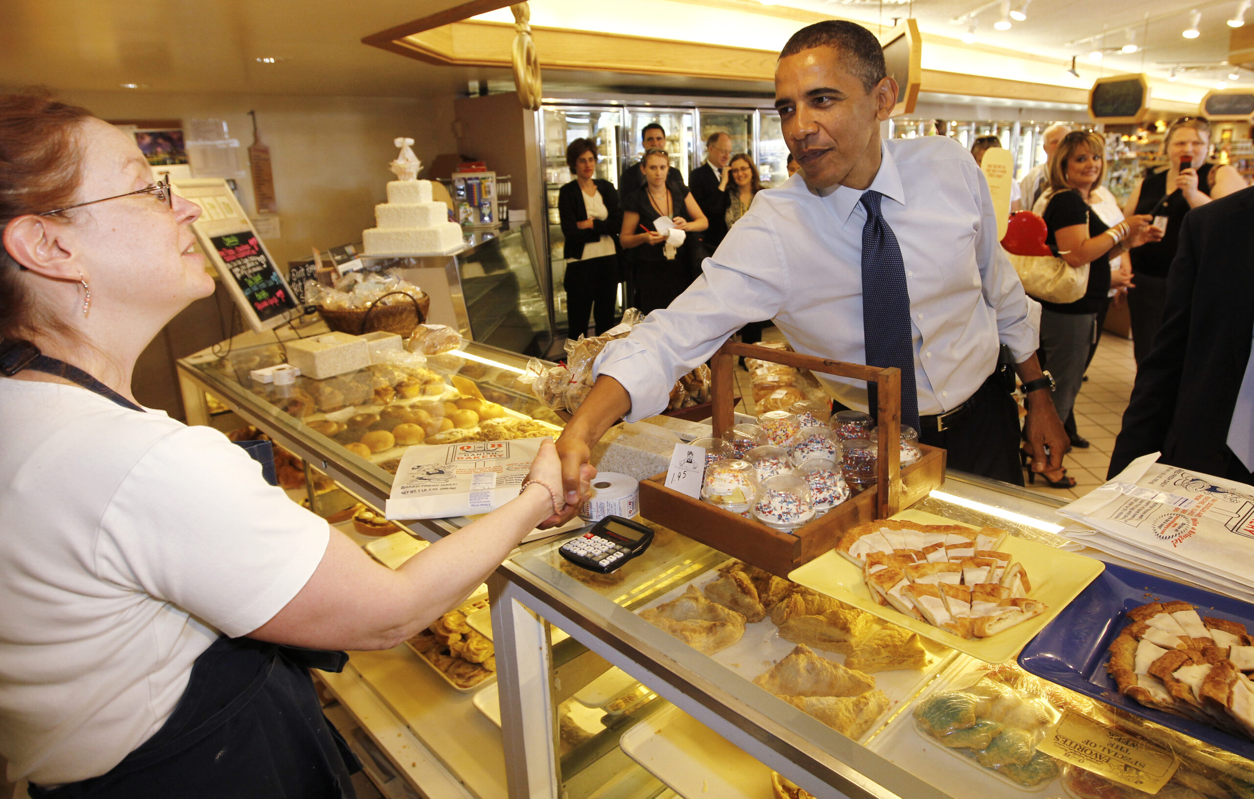President Barack Obama greets a Kringle baker as he makes an unscheduled visit to O&H Danish Bakery