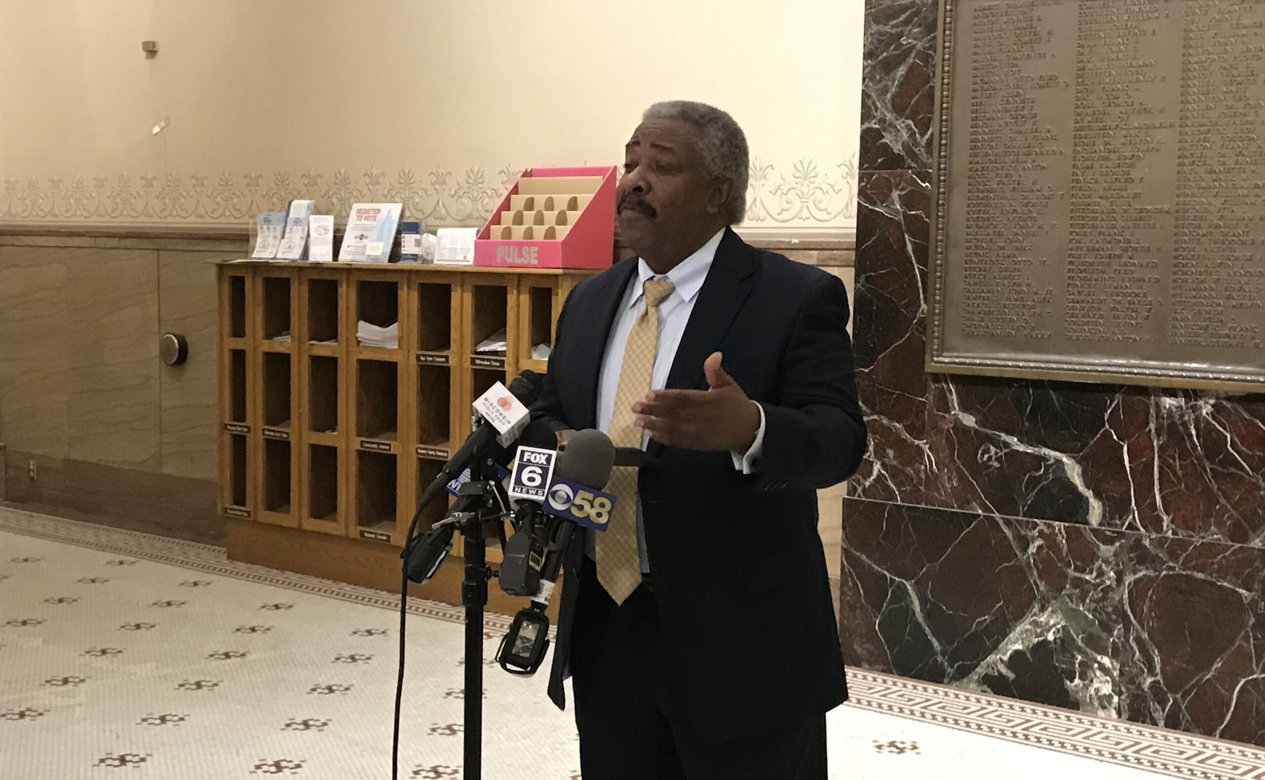 Milwaukee City Attorney Tearman Spencer speaks to reporters in the City Hall rotunda