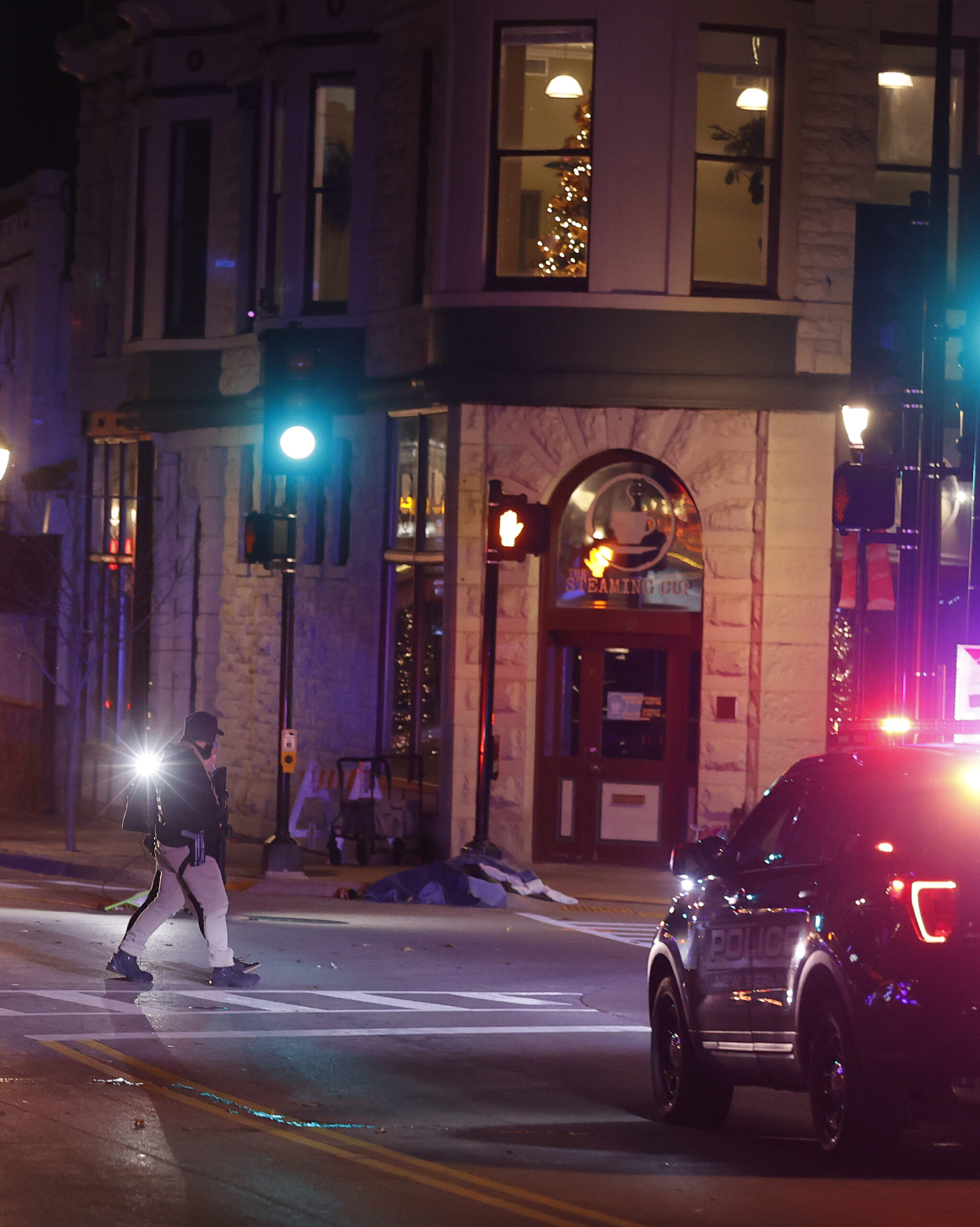 Police canvass the streets in downtown Waukesha after a vehicle plowed into a Christmas parade