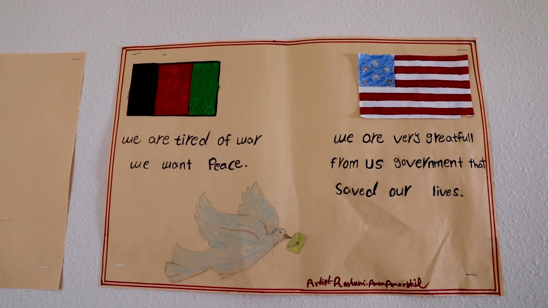 A hand-drawn poster shows an Afghan flag with the legend 