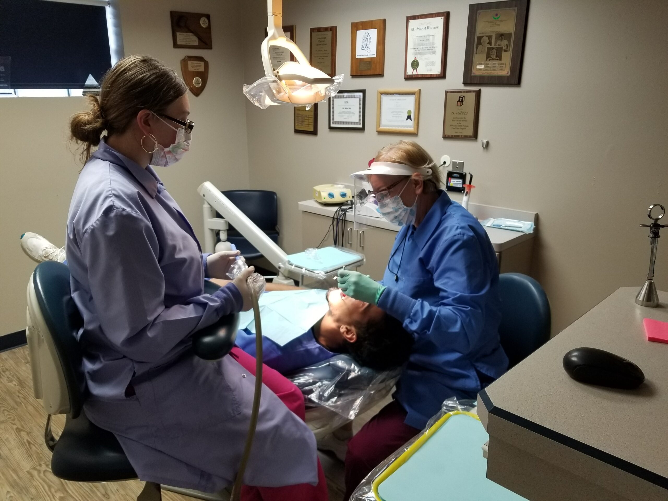 Dentist cares for patient.