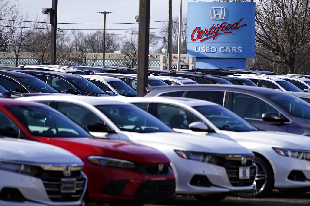 A dealership sign is seen outside of Honda certified used car dealership in Schaumburg, Ill., Thursday, Dec. 16, 2021.