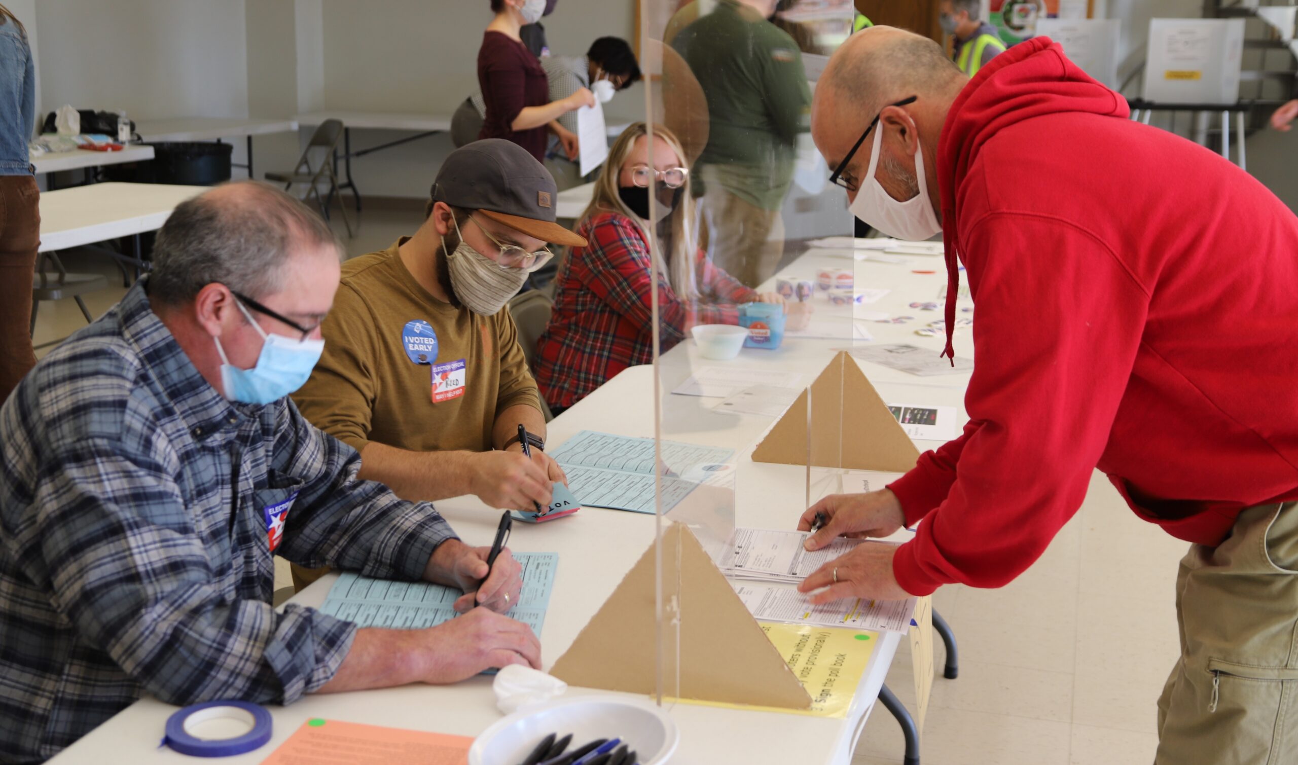 A voter turning in an absentee ballot in Madison, Wis.