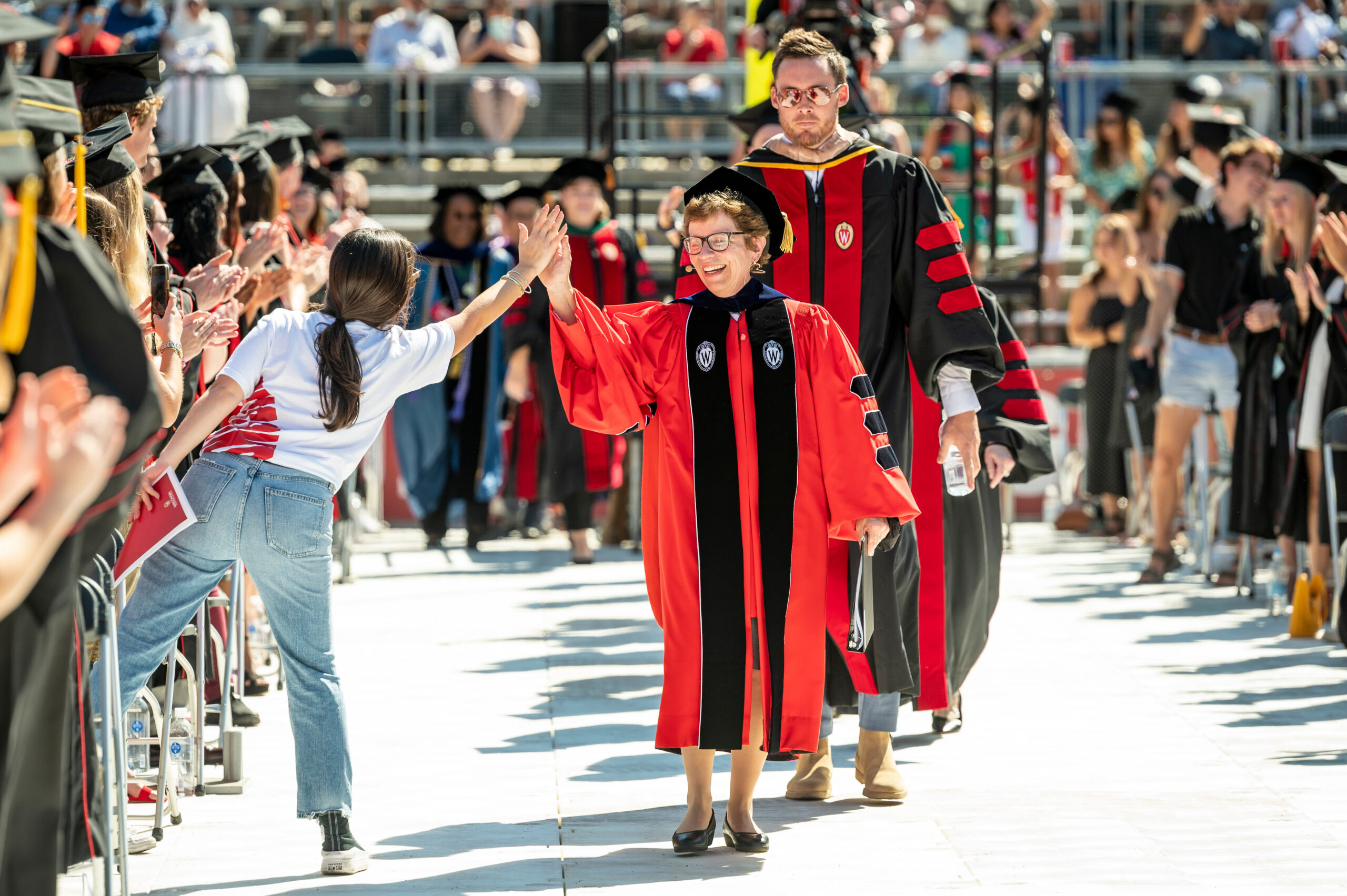 Chancellor Rebecca Blank high-fiving another person