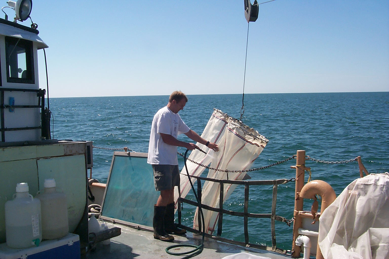Man with a Bongo net for sampling larval fish (icthyoplankton) in Lake Michigan.