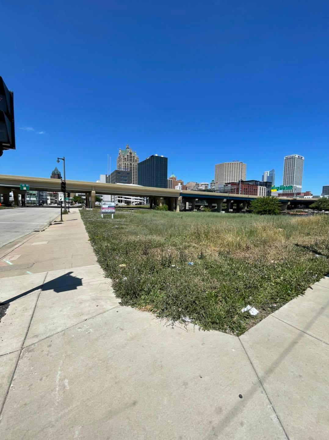 A vacant lot now filled with grass that sits where a gay bar in Milwaukee used to be