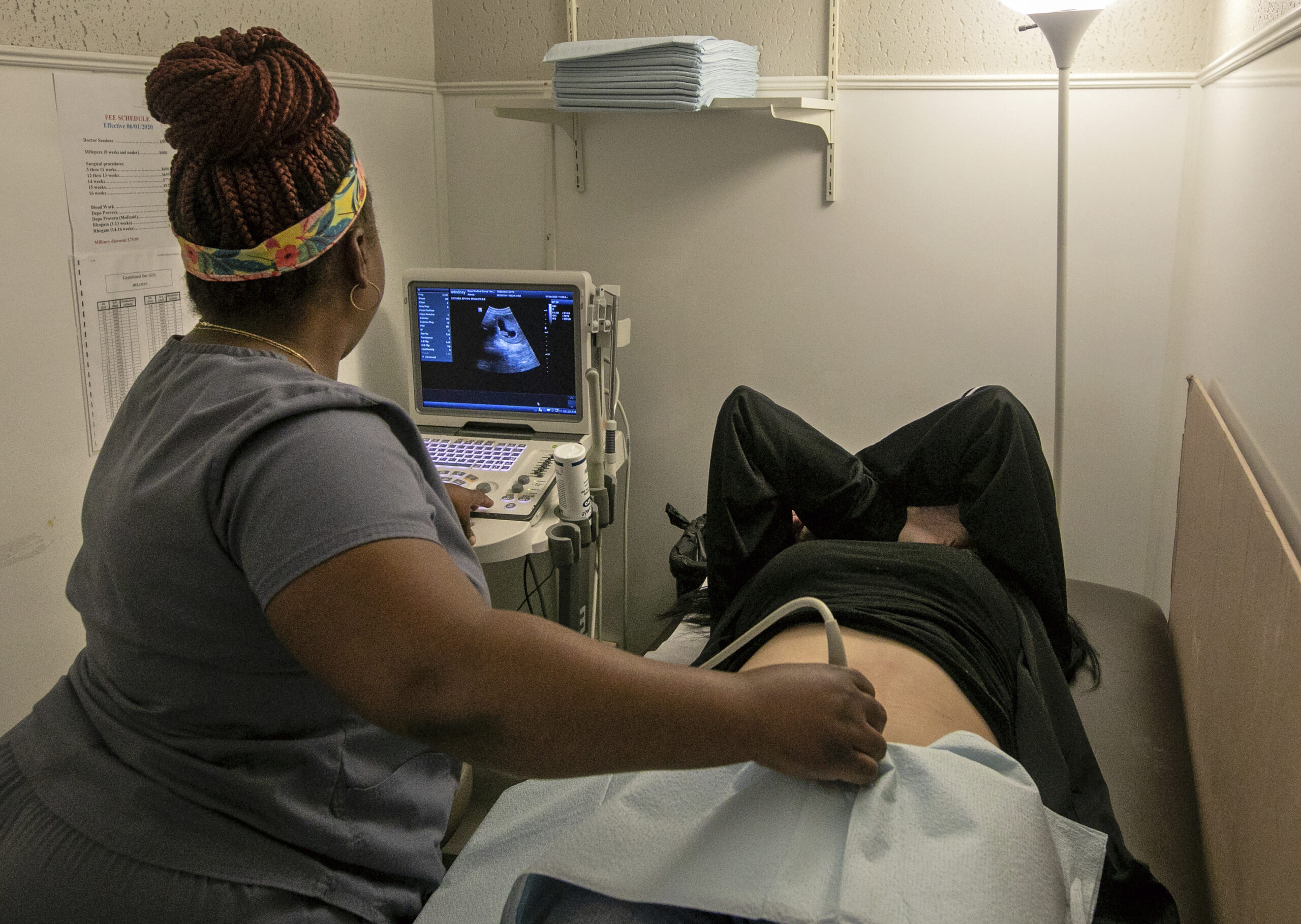 An operating room technician performs an ultrasound on a patient