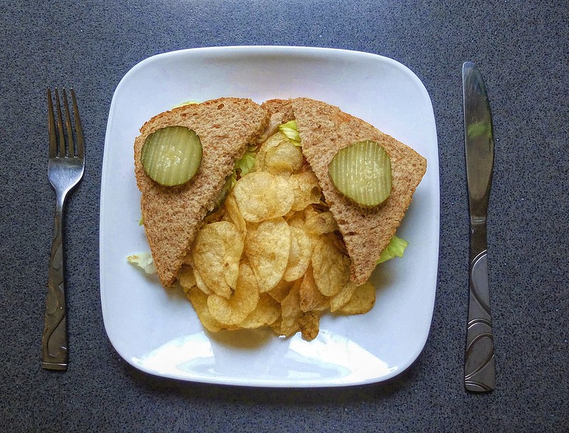 A sandwich with potato chips on a plate