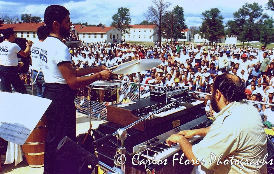 A crowd of Cuban refugees enjoys a concert featuring Eddie Palmieri