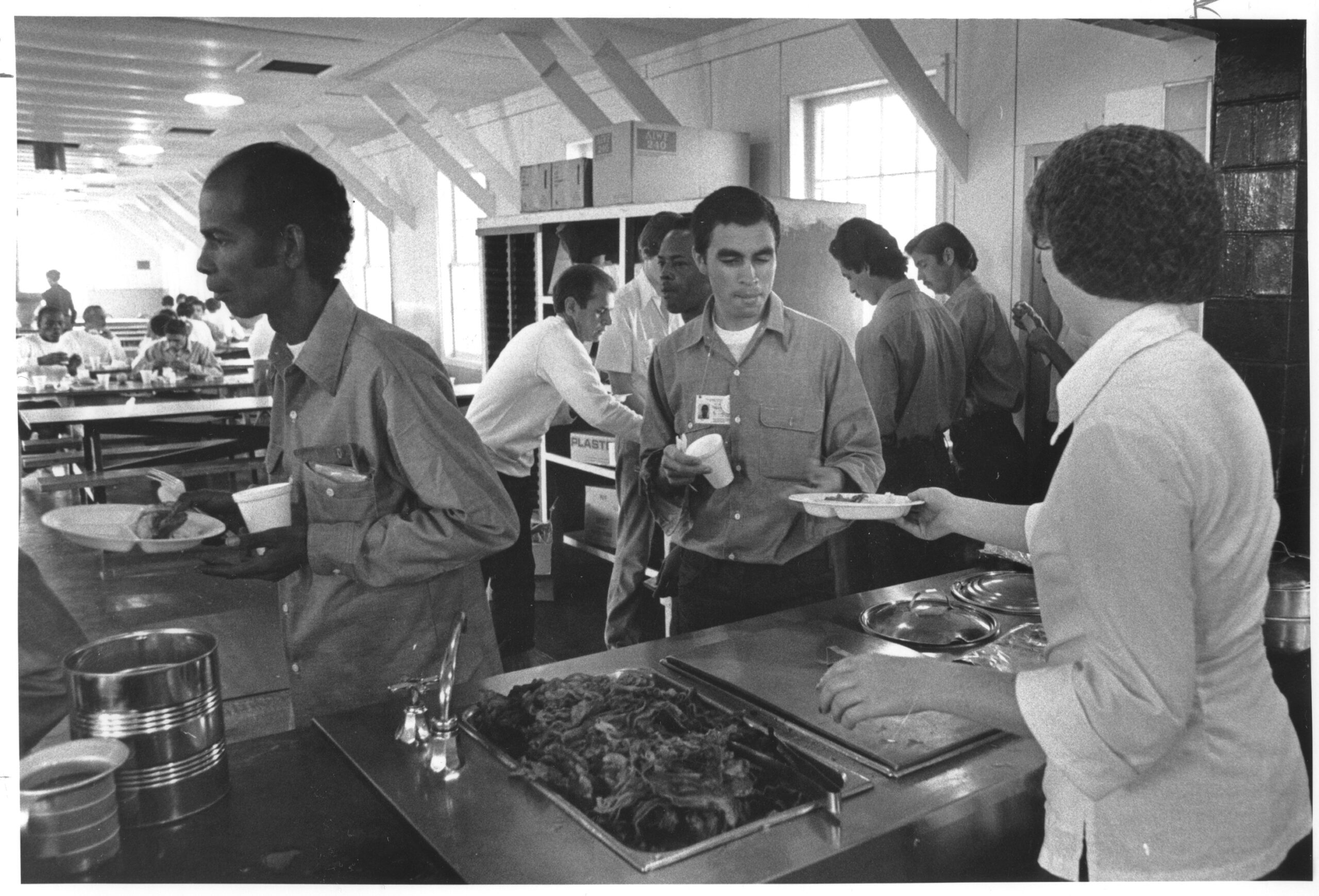 Cuban refugees at Fort McCoy in 1980 are in line at the mess hall