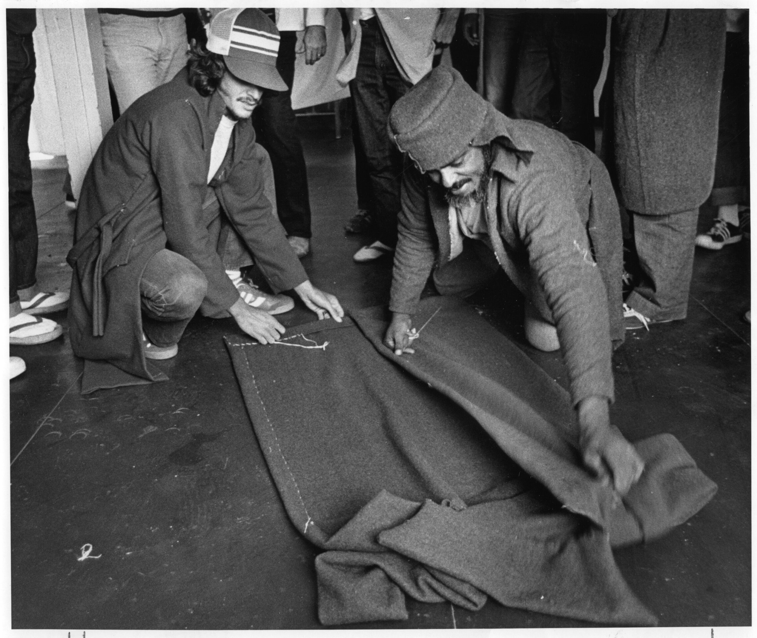 Cuban refugees making coats out of Army blankets