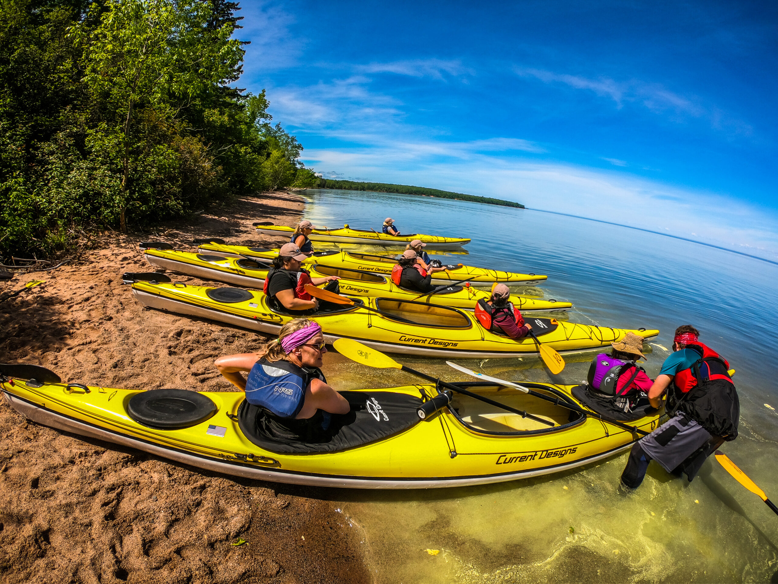 Wide shot of kayaks on a beach within the Apostle Islands