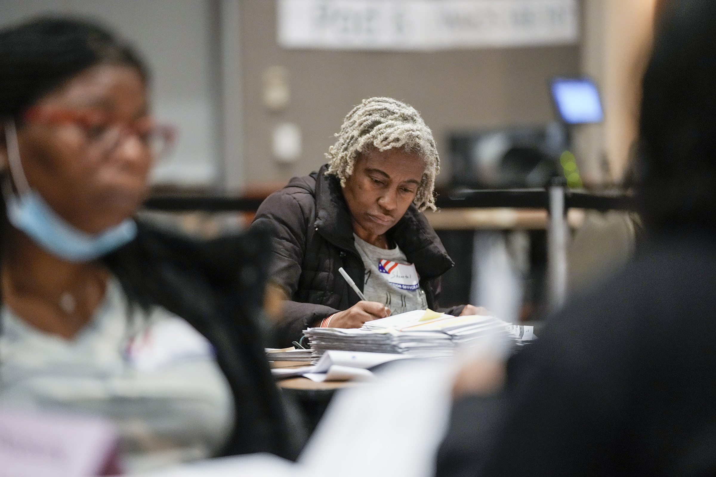Workers count absentee ballots at the Wisconsin Center for the midterm election