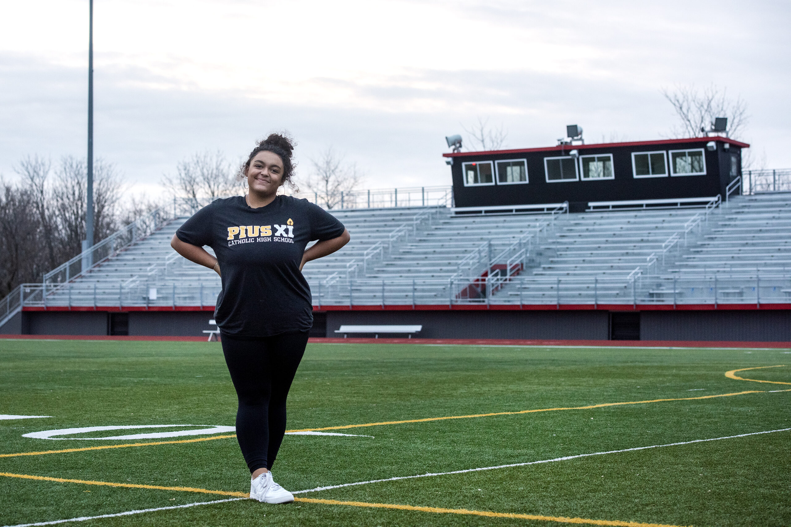 Hannah Peters stands on a football field.