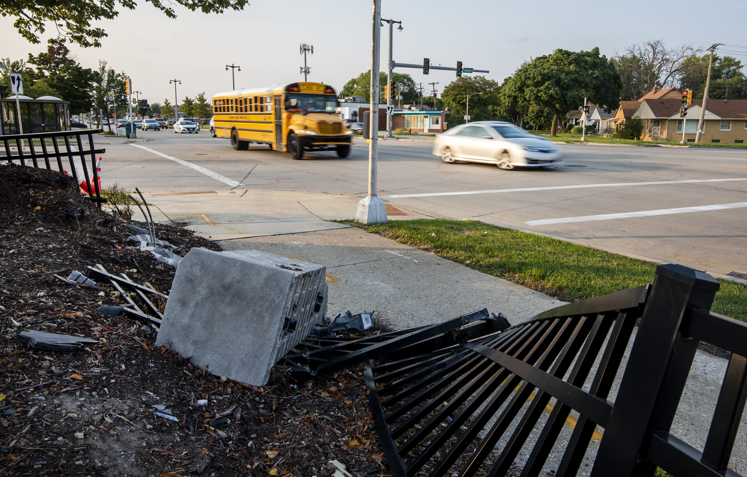 Vehicles drive by a car crash site in Milwaukee.