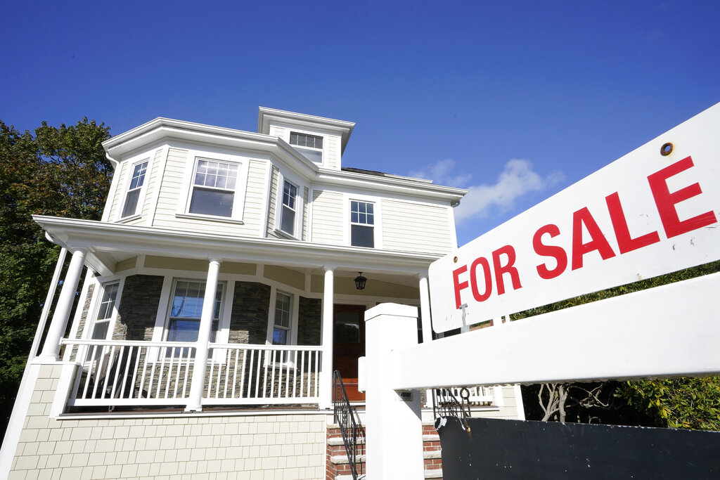 A for sale sign in front of a house.