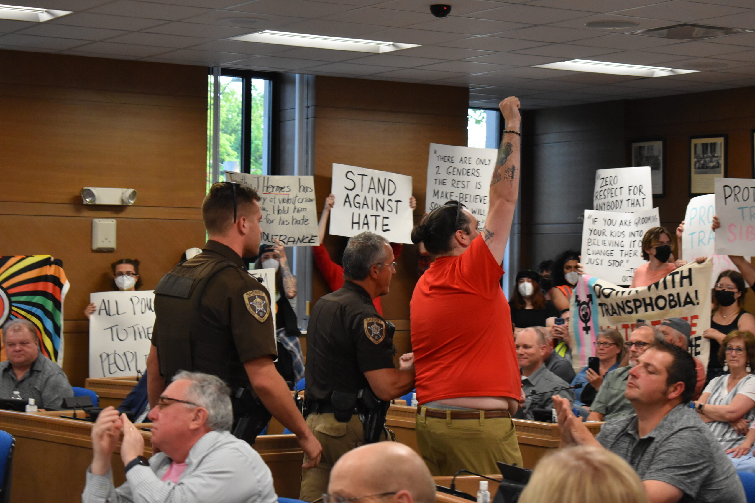 Activist Jay Gibbs is escorted out of the Outagamie County Board room