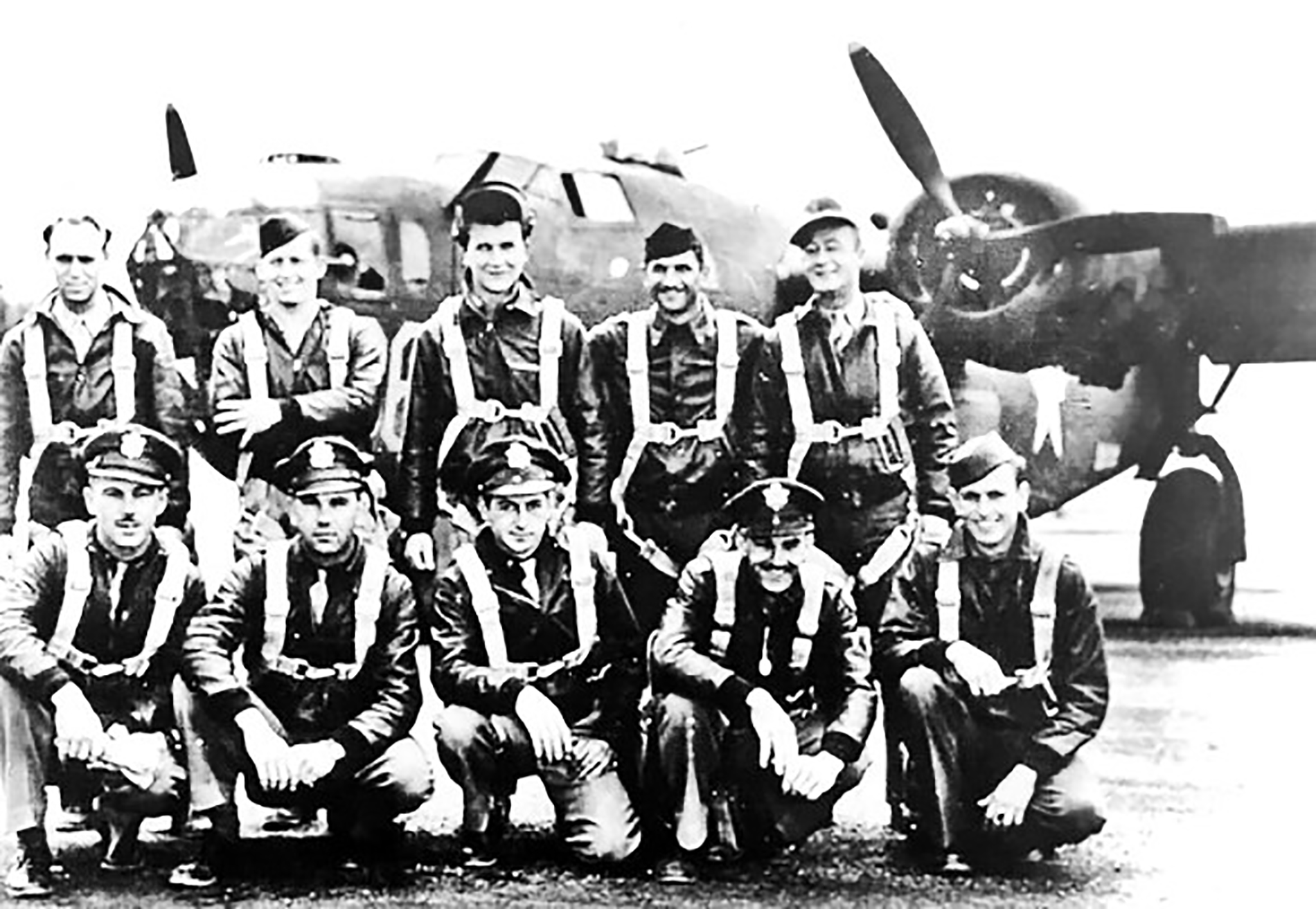First Lt. Roy C. Harms with a WWII bomber plane and his crew.