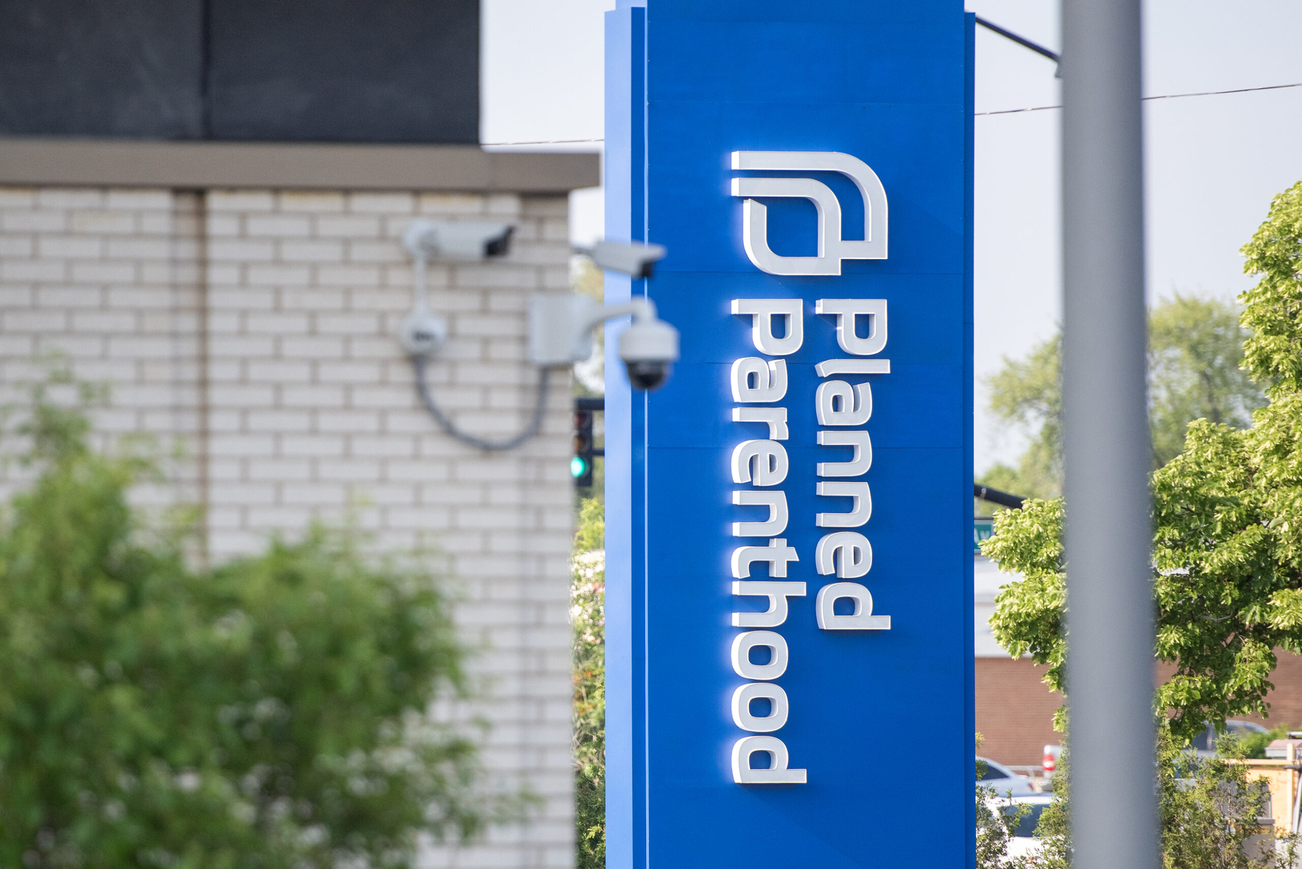 A blue sign says "Planned Parenthood."