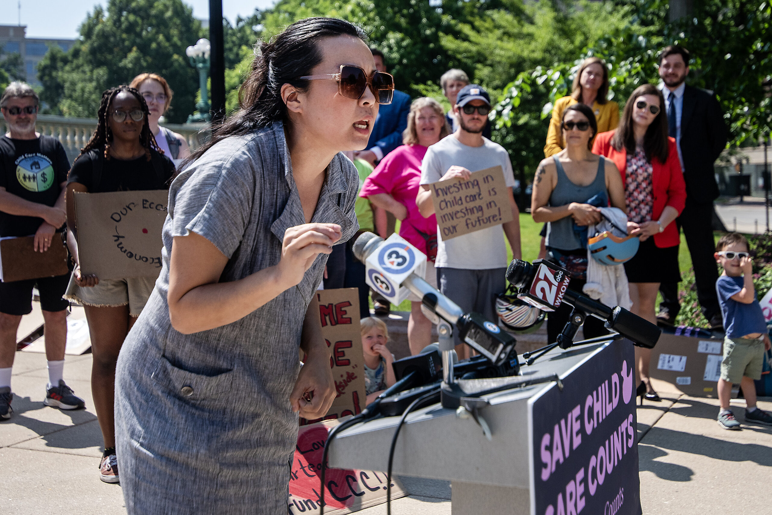 Rep. Francesca Hong gestures as she speaks at a podium.