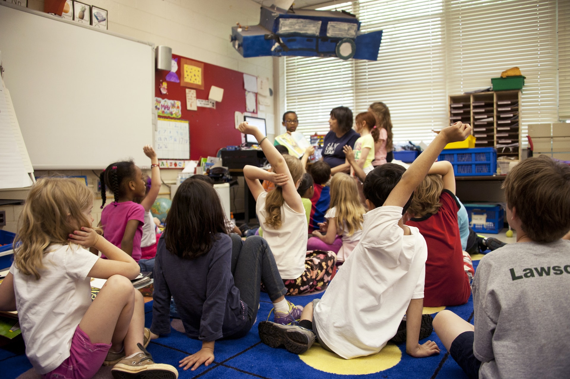 Students sitting on the floor in a classroom