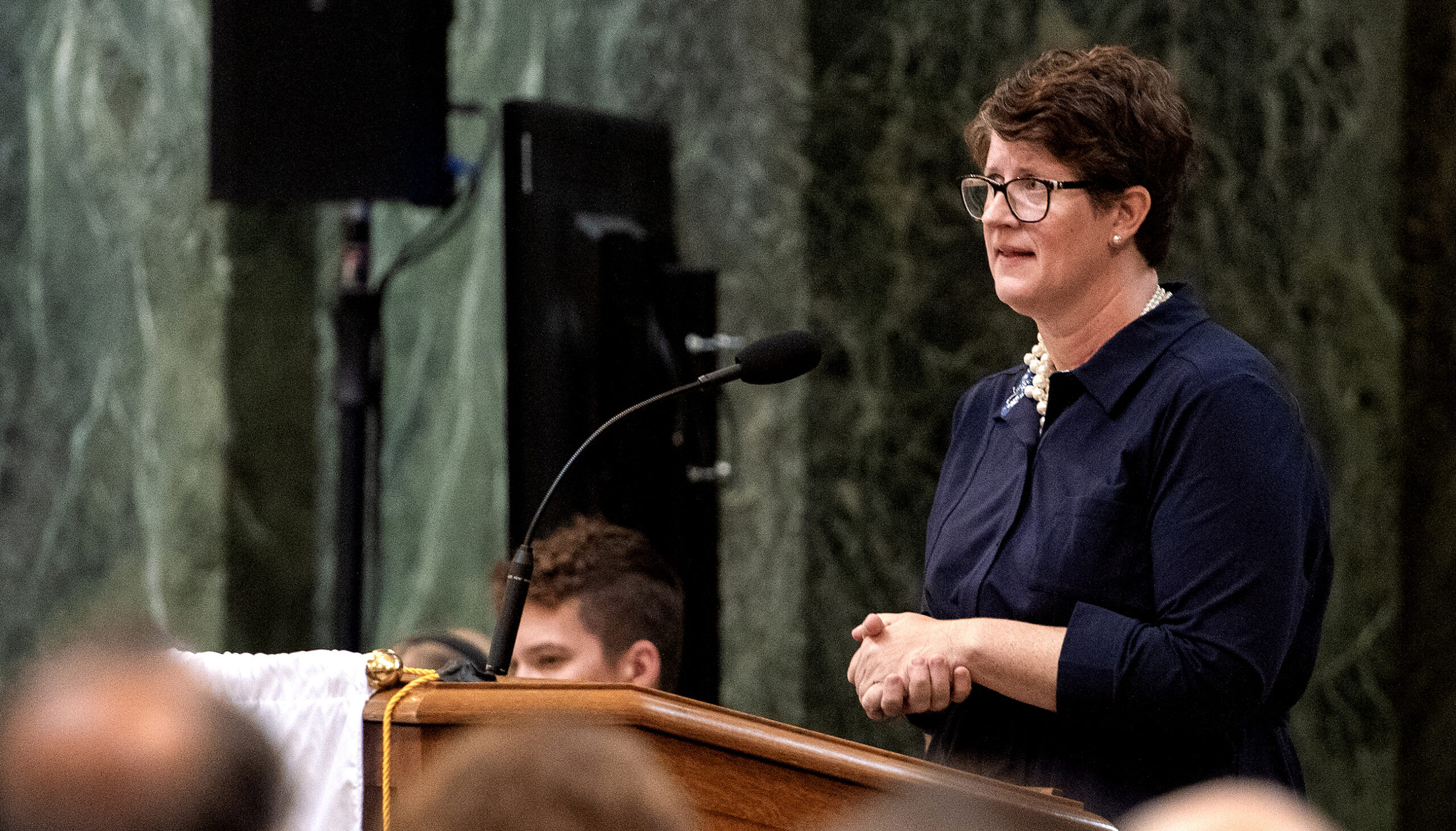 Jill Underly speaks at a podium in front of a crowd