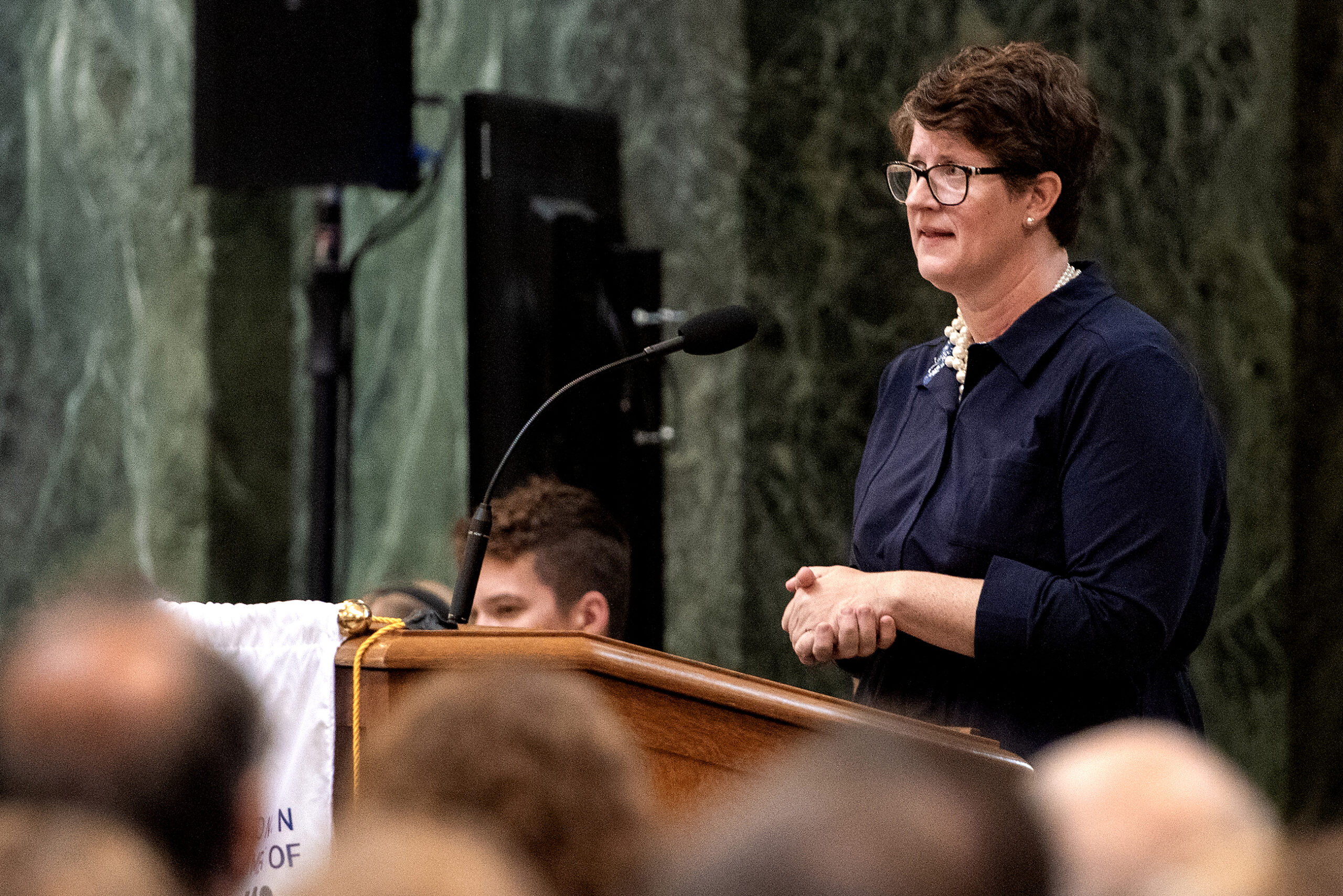 Jill Underly speaks at a podium in front of a crowd