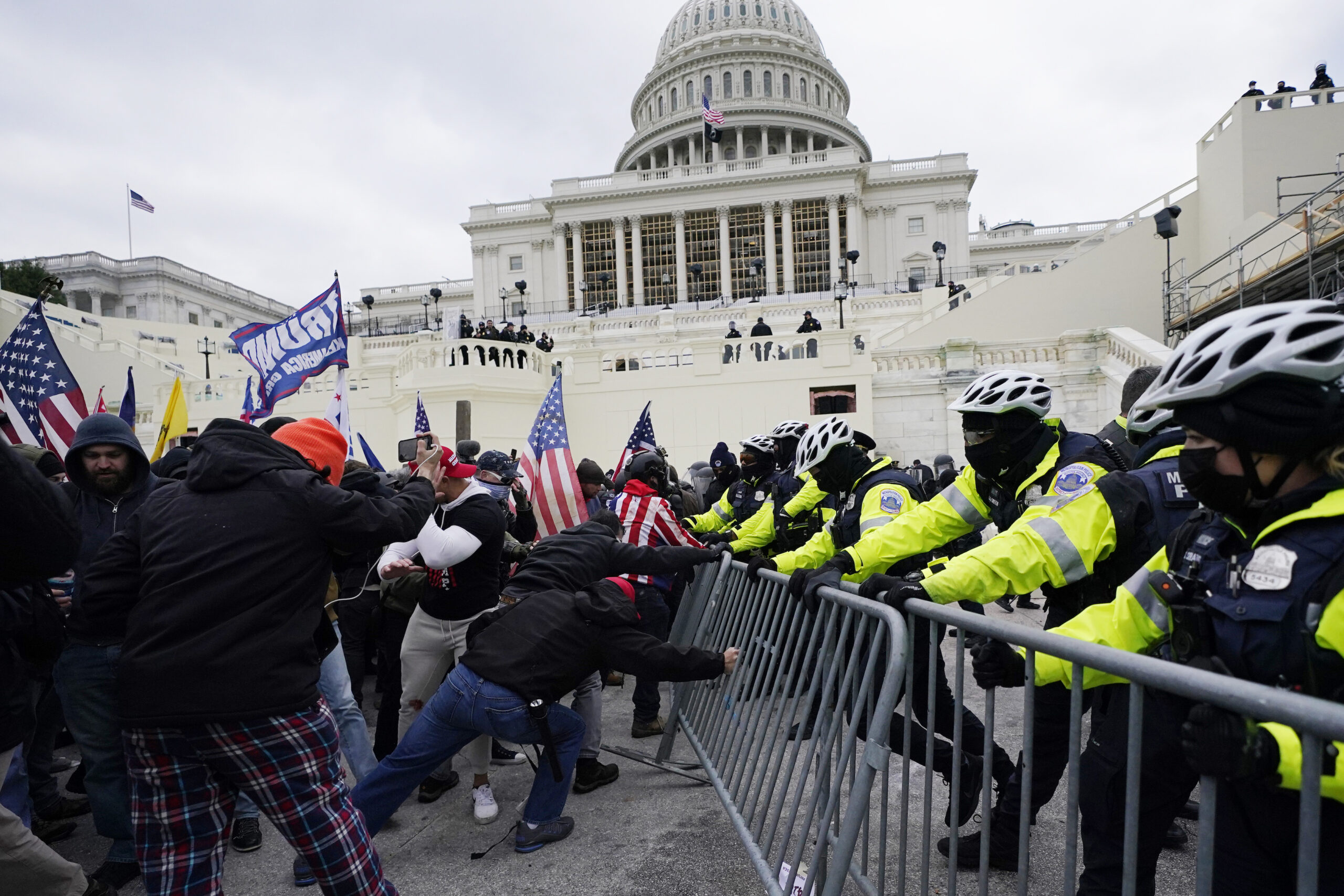 Rioters struggling with police over a barricade in front of the U.S. Capitol