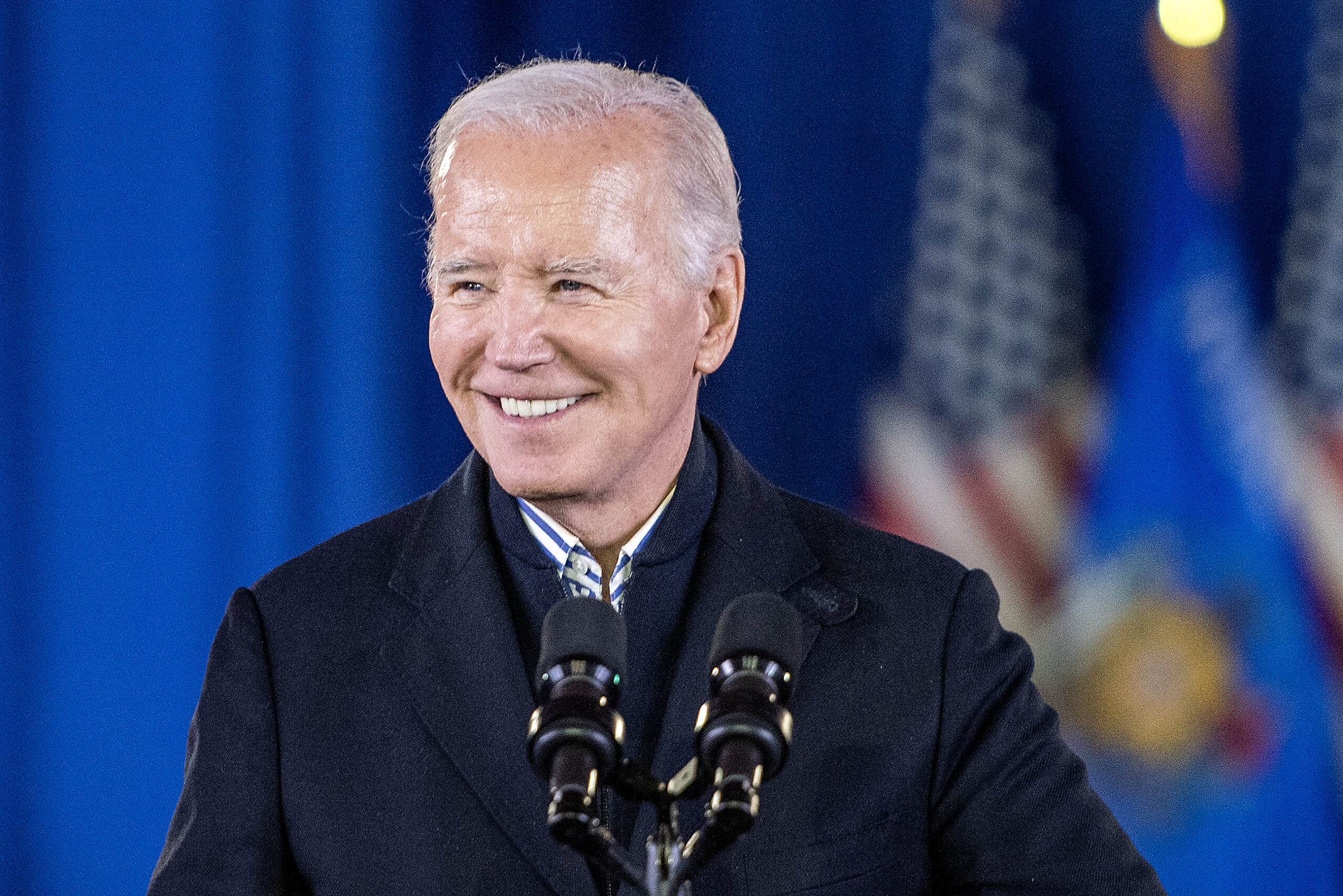 Biden smiles as he arrives on stage.